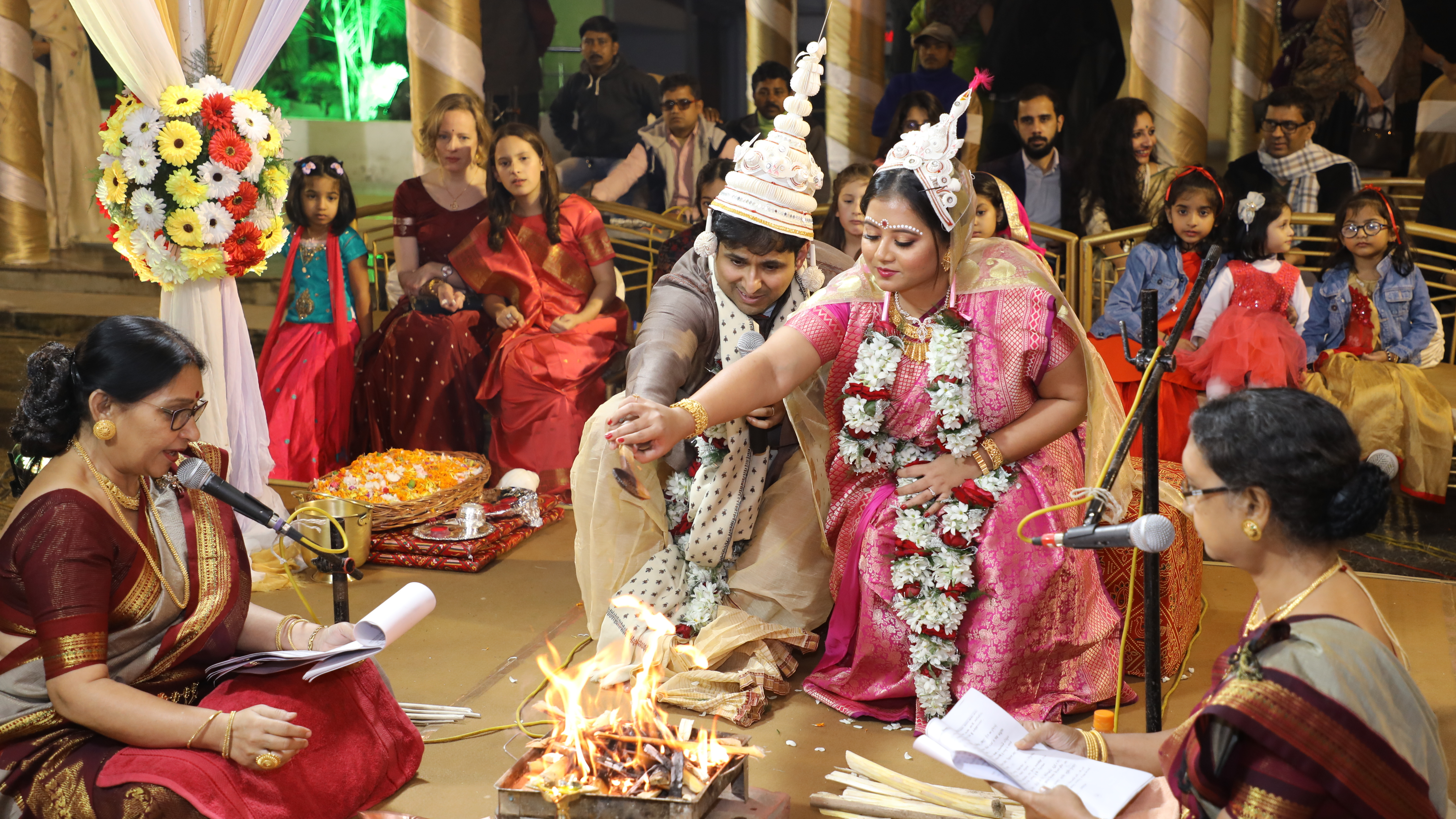 Sharmistha Chaudhuri (center, wearing pink), 35, at her wedding in Kolkata, India, in January 2020. Chaudhuri found some Indian wedding traditions retrograde, so she hired four feminist priestesses to officiate at hers. They performed a multilingual, egalitarian ceremony stripped of patriarchal traditions.