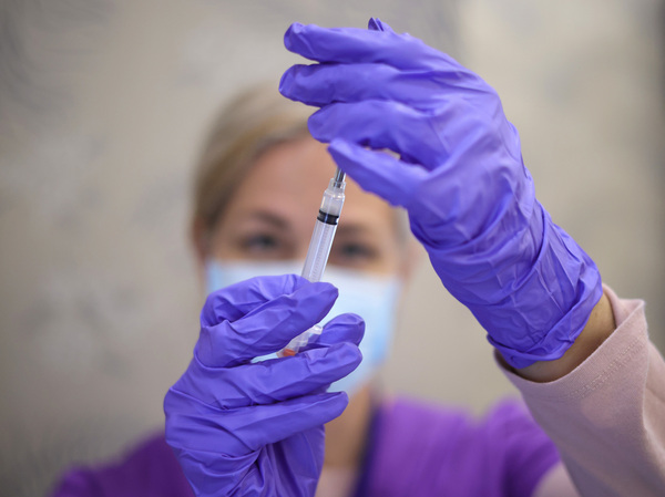 A nurse draws a vaccine dose from a vial of Moderna's COVID vaccine at the Cameron Grove Community Center in Bowie, Md., in March.