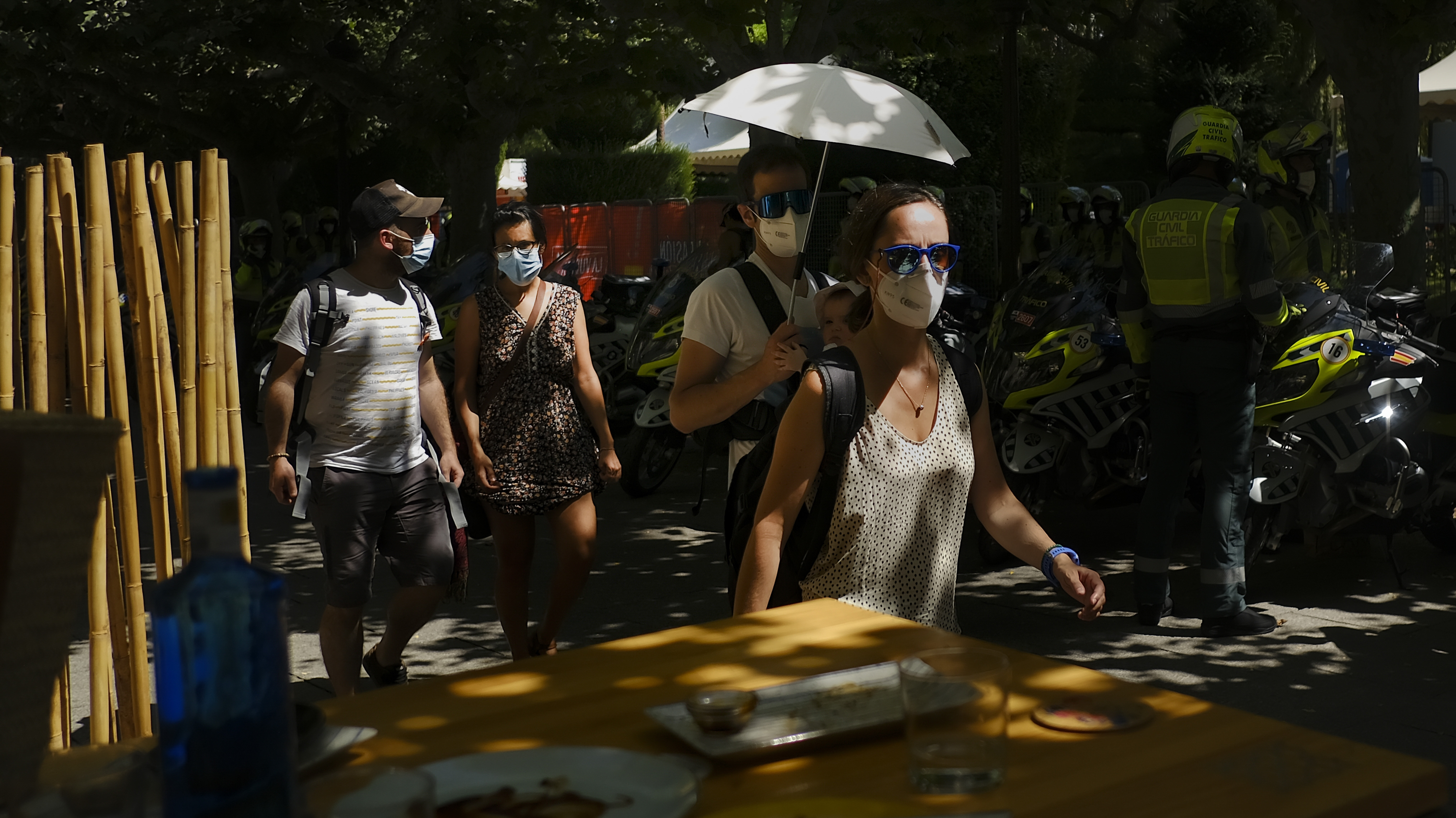 A man shelters a baby from the sun with an umbrella during a heatwave in Burgos, northern Spain, Saturday, Aug. 14, 2021. Cities in Europe saw recording-setting heat this summer, with some regions reaching 117.3°F.