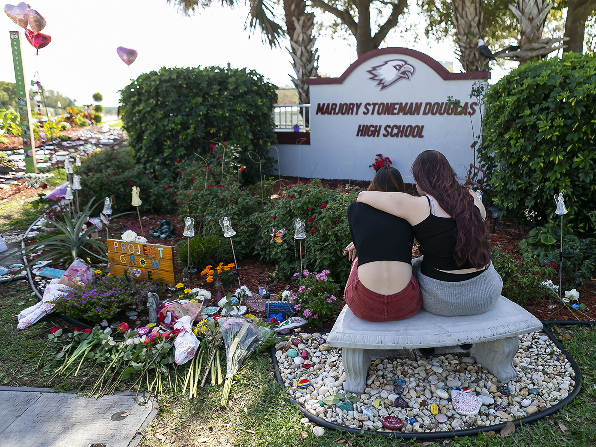 Mourners visit a makeshift memorial outside Marjory Stoneman Douglas High School in Parkland, Fla., on Feb. 14, 2020, during the two-year anniversary of the Parkland shooting that killed 17 people and injured another 17. (Miami Herald/Tribune News Service/Getty Images)
