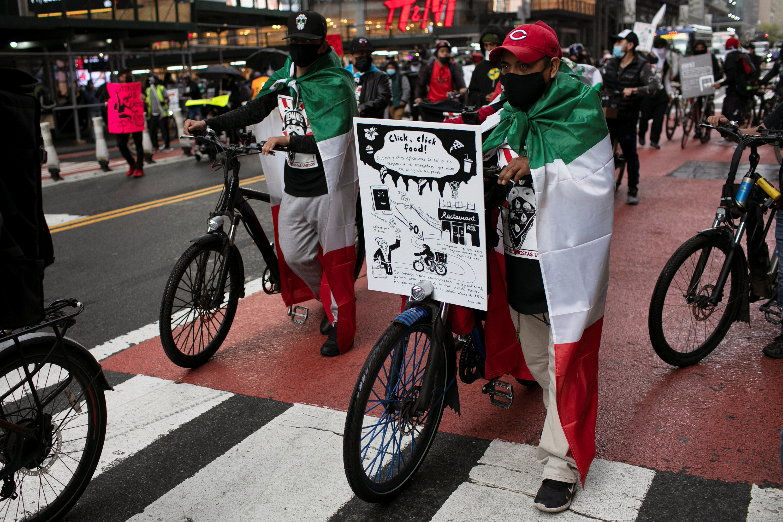 Food delivery riders take part in a street protest ride organized by the group &quot;Los Deliveristas Unidos,&quot; demanding better working conditions, pay and protections in Times Square in New York City on April 21, 2021. (Reuters)