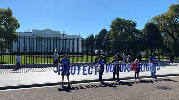 Voting rights activists demonstrate outside the White House on Tuesday. Many of them have been frustrated that President Biden hasn't more forcefully advocated for voting rights legislation.