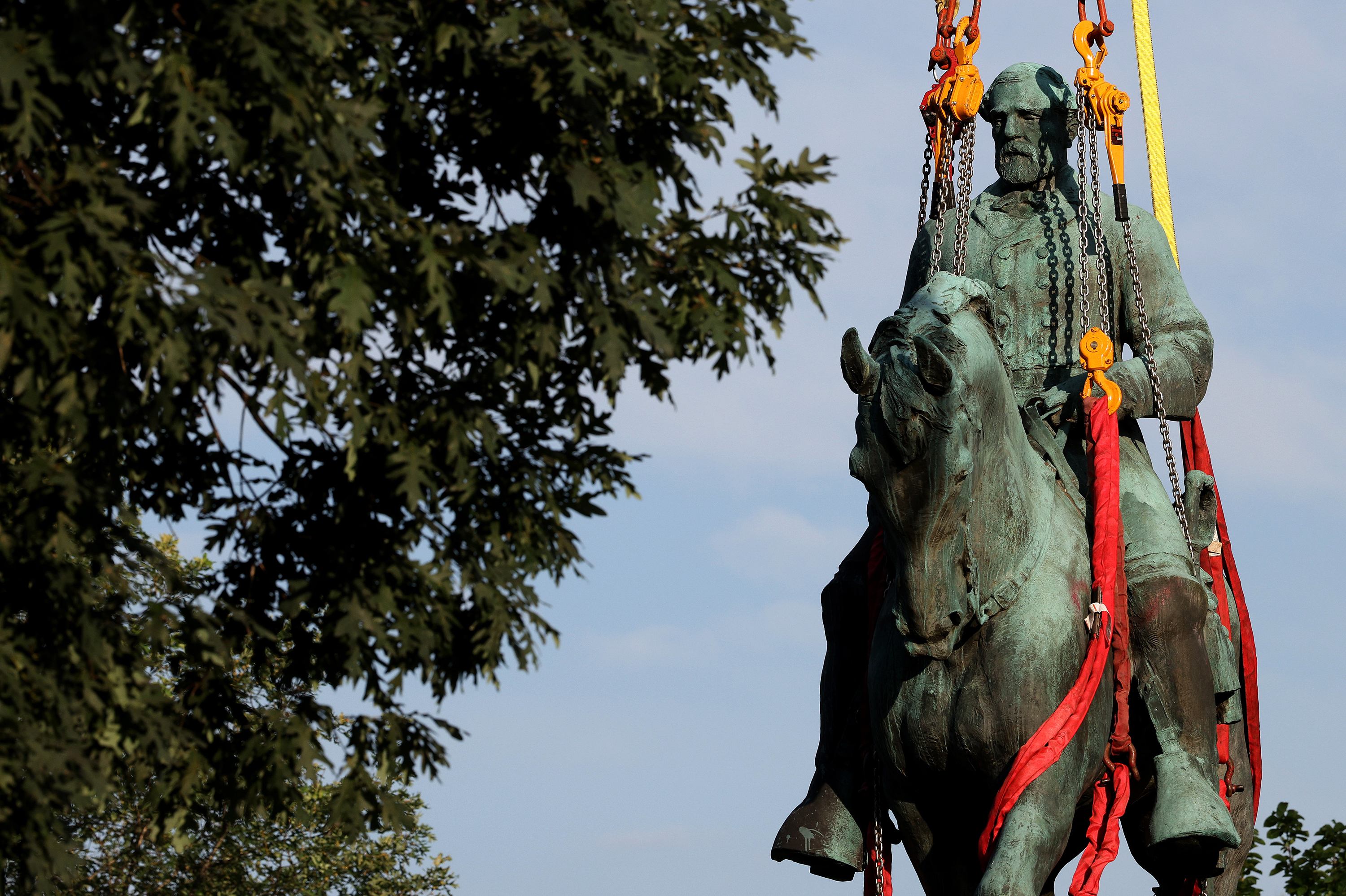 Workers remove a statue of Confederate Gen. Robert E. Lee from Market Street Park in Charlottesville, Va., in July. Initial plans to remove the statue four years ago sparked the infamous &quot;Unite the Right&quot; rally at which 32-year-old Heather Heyer was killed. (Getty Images)