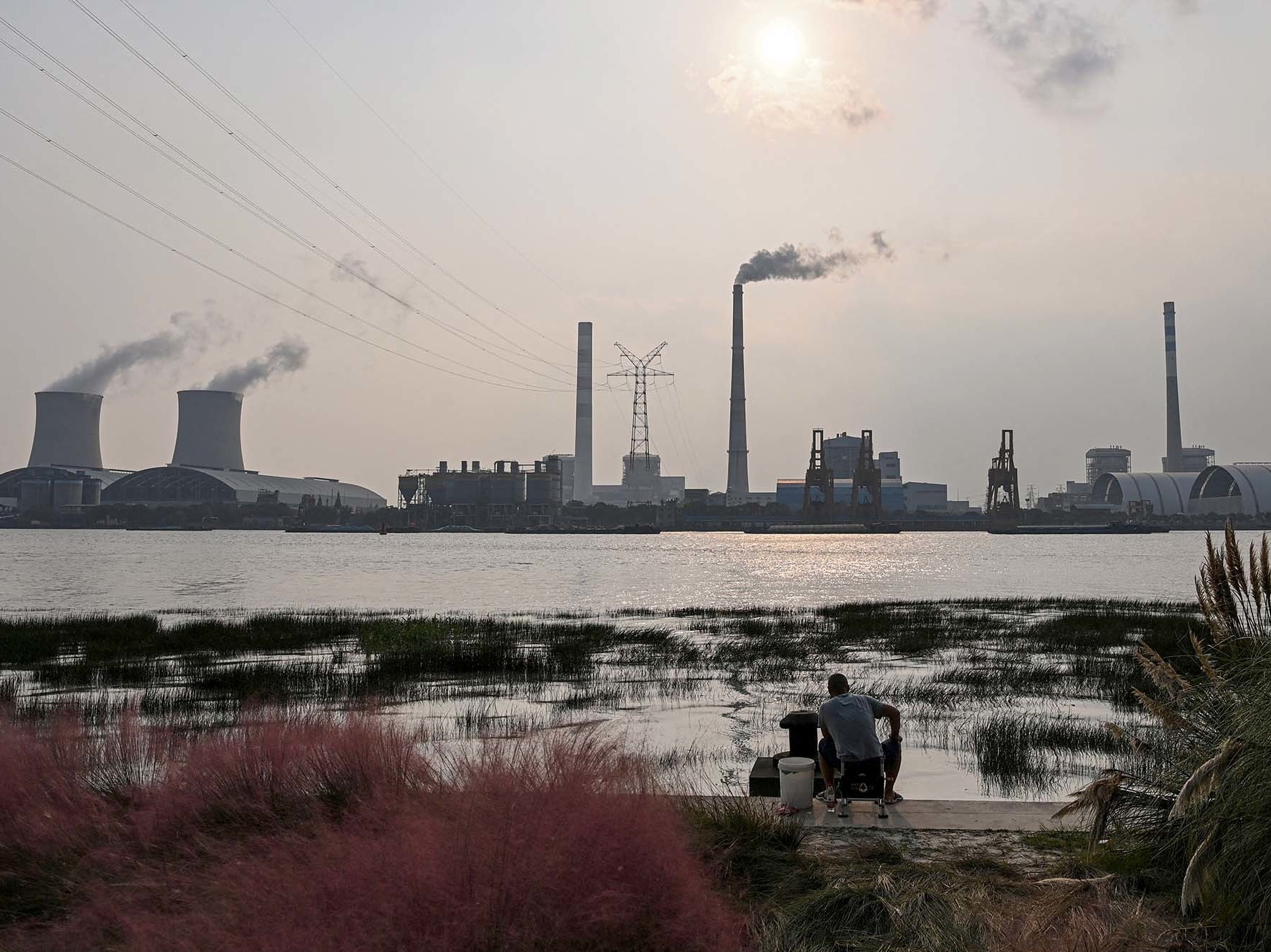 Scientists warn the world needs to dramatically reduce fossil fuel use, but many countries still depend on coal power, like from the Wujing Coal-Electricity Power Station in Shanghai, China. (AFP via Getty Images)