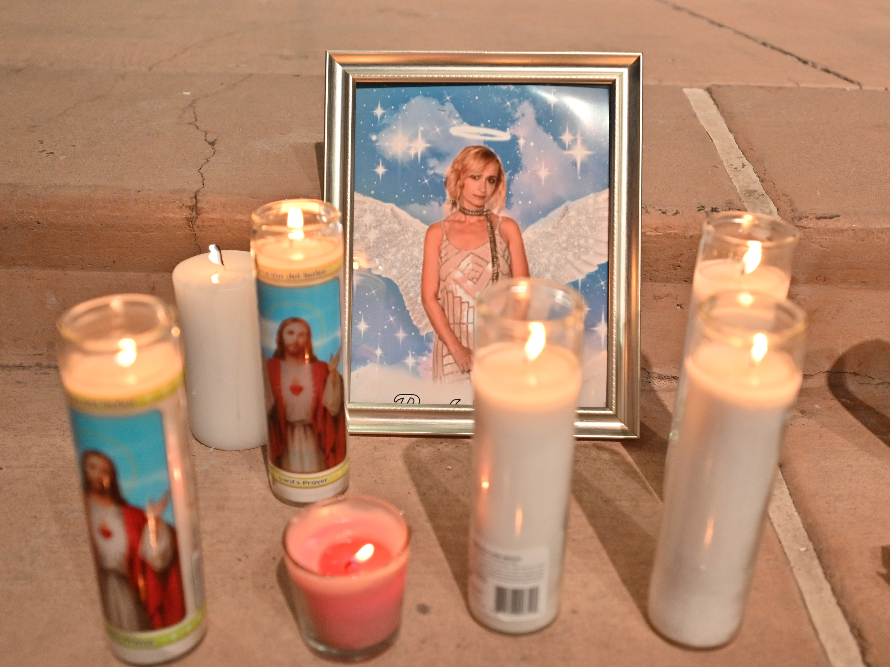 Candles surround a photo of cinematographer Halyna Hutchins during a vigil on Oct. 23 in Albuquerque, New Mexico. The American Film Institute established a scholarship in honor of Hutchins, who was killed by a prop gun on the set of the movie &quot;Rust&quot; last week. (Getty Images)