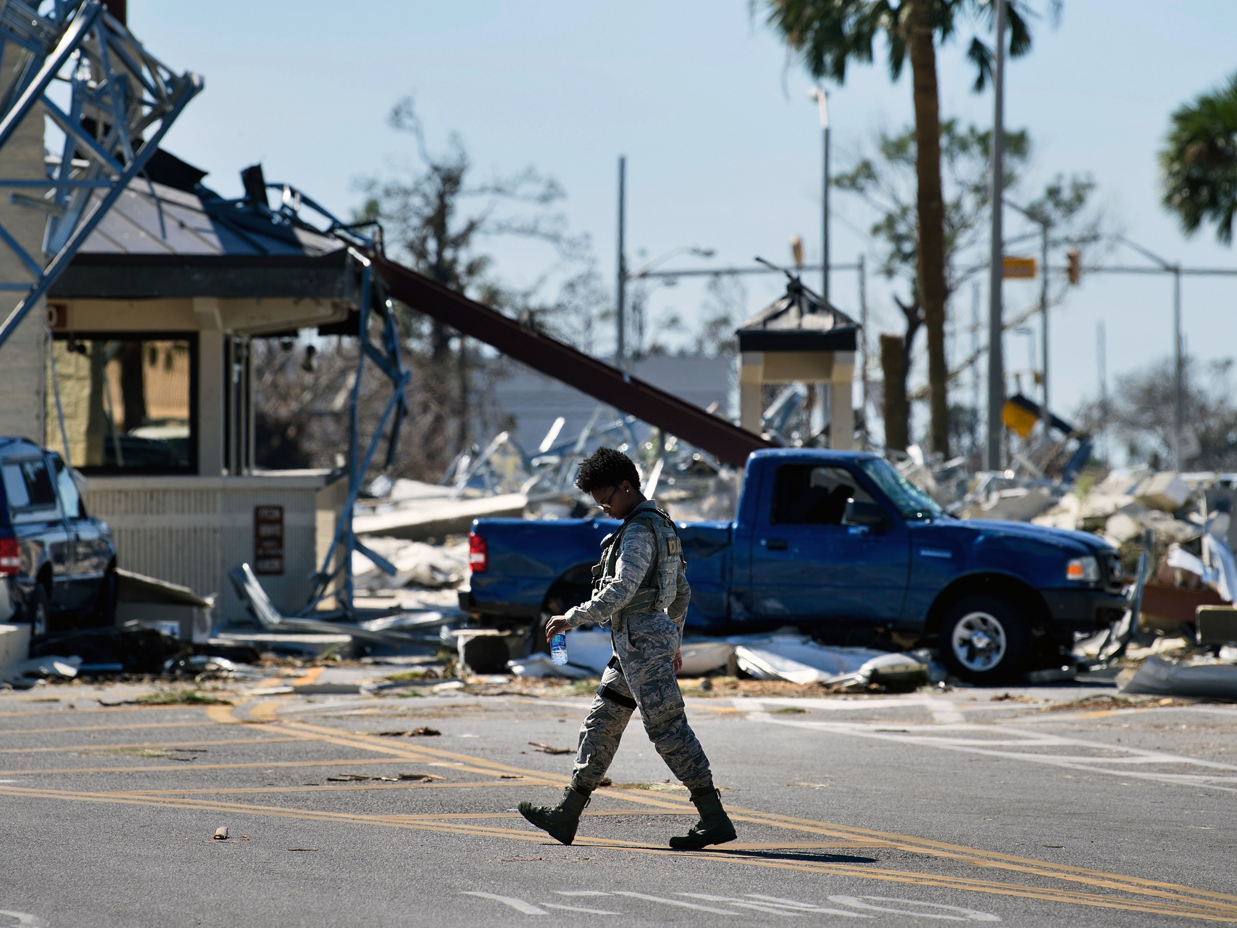 A military police officer walks near a destroyed gate in Tyndall Air Force Base in Florida in the aftermath of Hurricane Michael on Oct. 12, 2018. The Pentagon says climate change is a national security concern. (AFP via Getty Images)