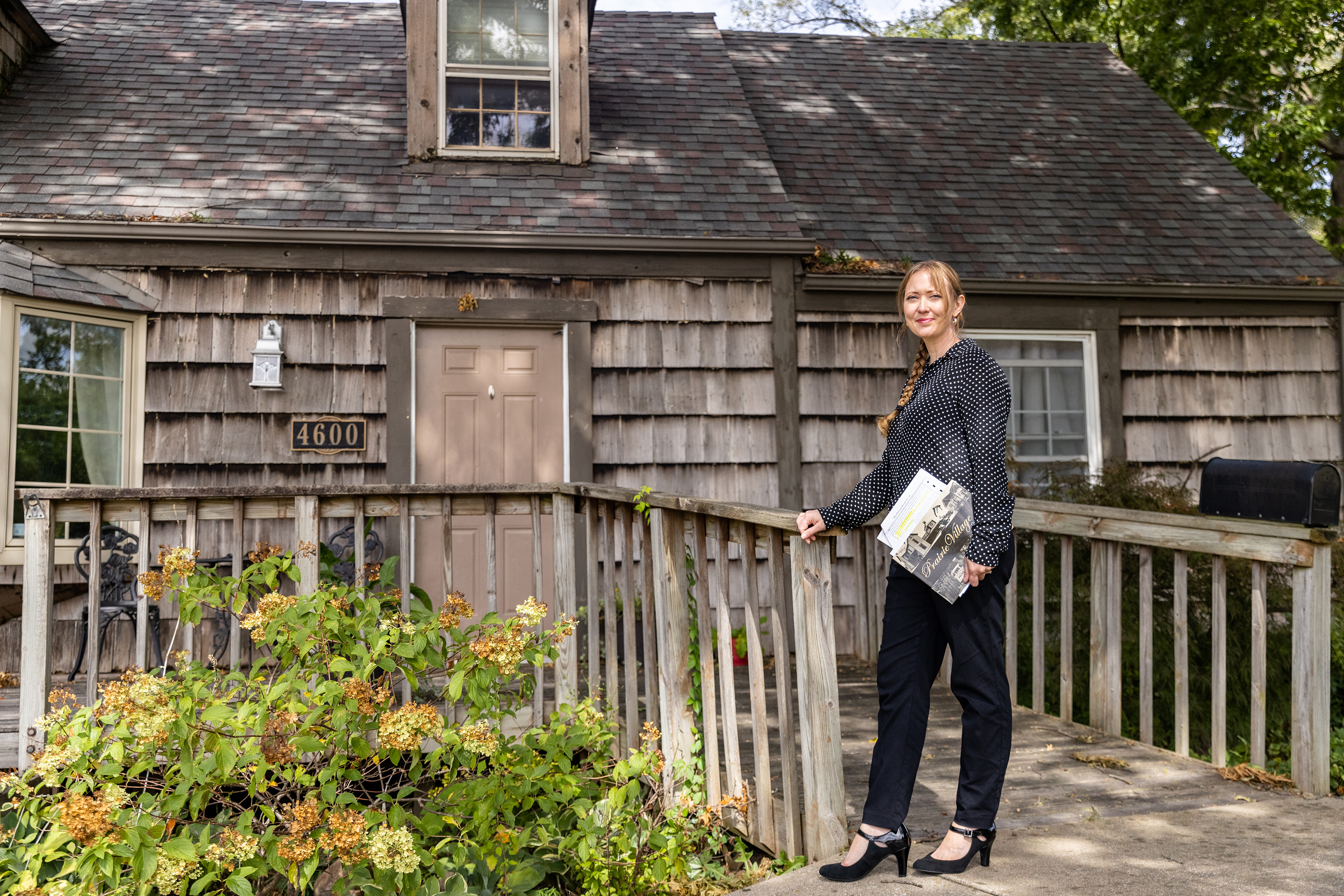 Council Member Inga Selders stands in front of her childhood home, where she currently lives with her family in Prairie Village, Kan. Selders stumbled upon a racially restrictive housing covenant<strong> </strong>in her homeowners association property records. (Katie Currid for NPR)