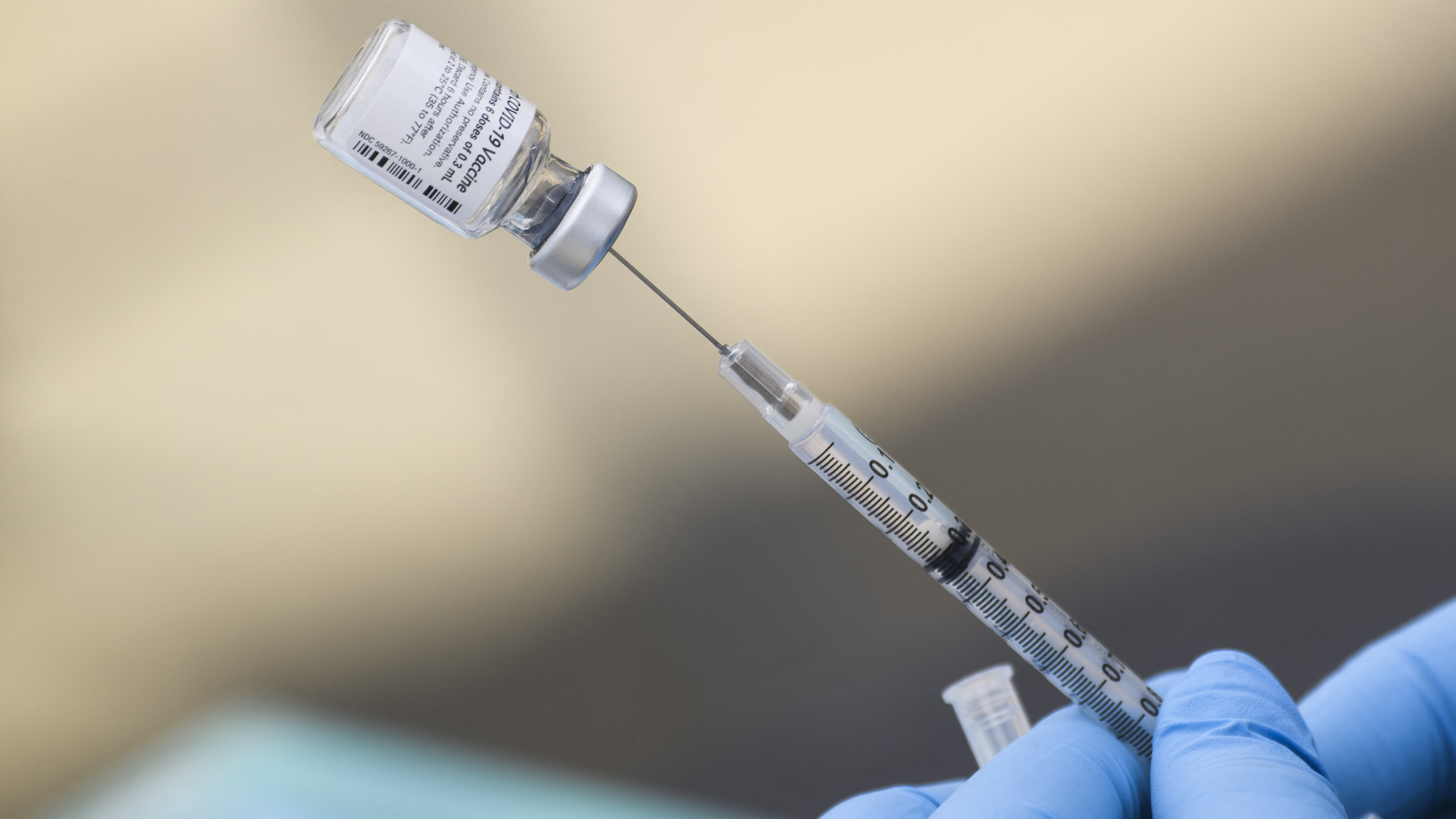 A syringe is filled with a dose of the Pfizer-BioNTech COVID-19 vaccine. While the vaccine has now been authorized for children between ages 5 and 11, it may take several weeks for shots to become widely available.