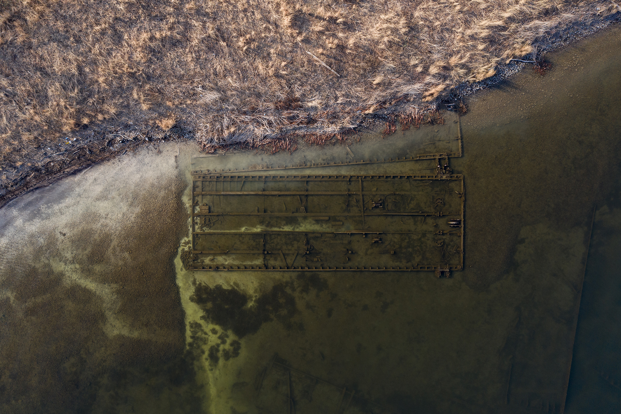 Songs and Pictures For Climate Change: A Playlist for the Planet 6 Syracuse, New York: A rusted installation at Onondaga lake. The lake was a dumping ground for soda ash waste and is one of the most polluted lakes in America. After years of dredging, the water quality of the lake is slowly returning to levels.