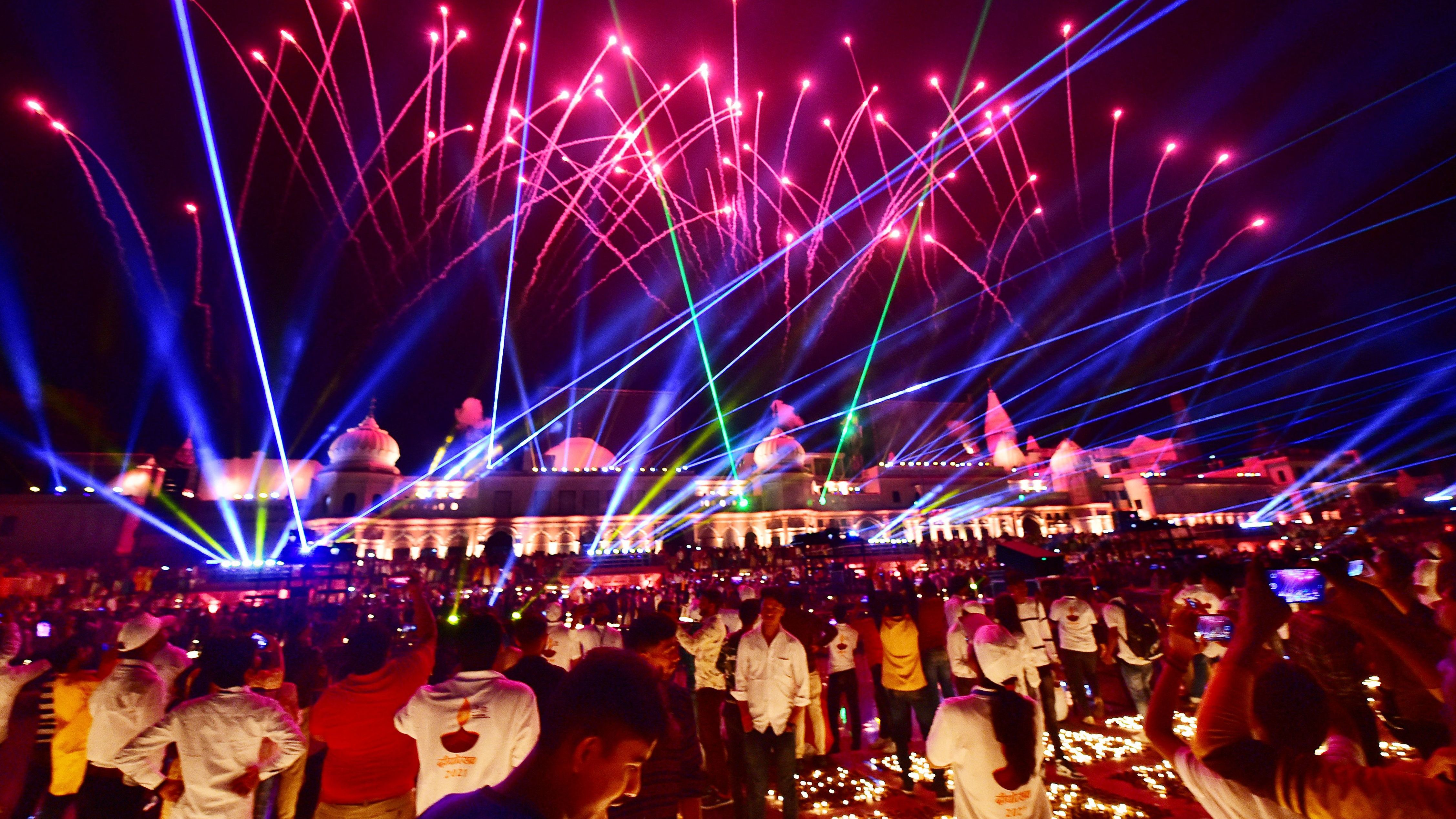 People watch a laser show on the banks of the river Sarayu during Deepotsav celebrations on the eve of the Hindu festival of Diwali in Ayodhya on Wednesday. The five-day festival celebrates the victory of light over darkness.