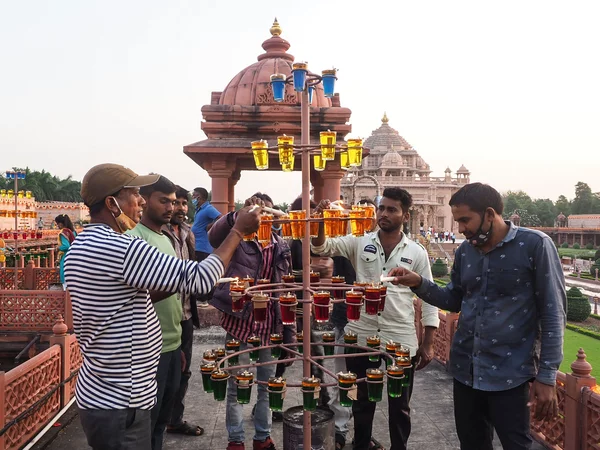 People light oil lamps on the eve of Diwali at the Akshardham Hindu temple in Gandhinagar, India, on Wednesday. Sam Panthaky/AFP via Getty Images