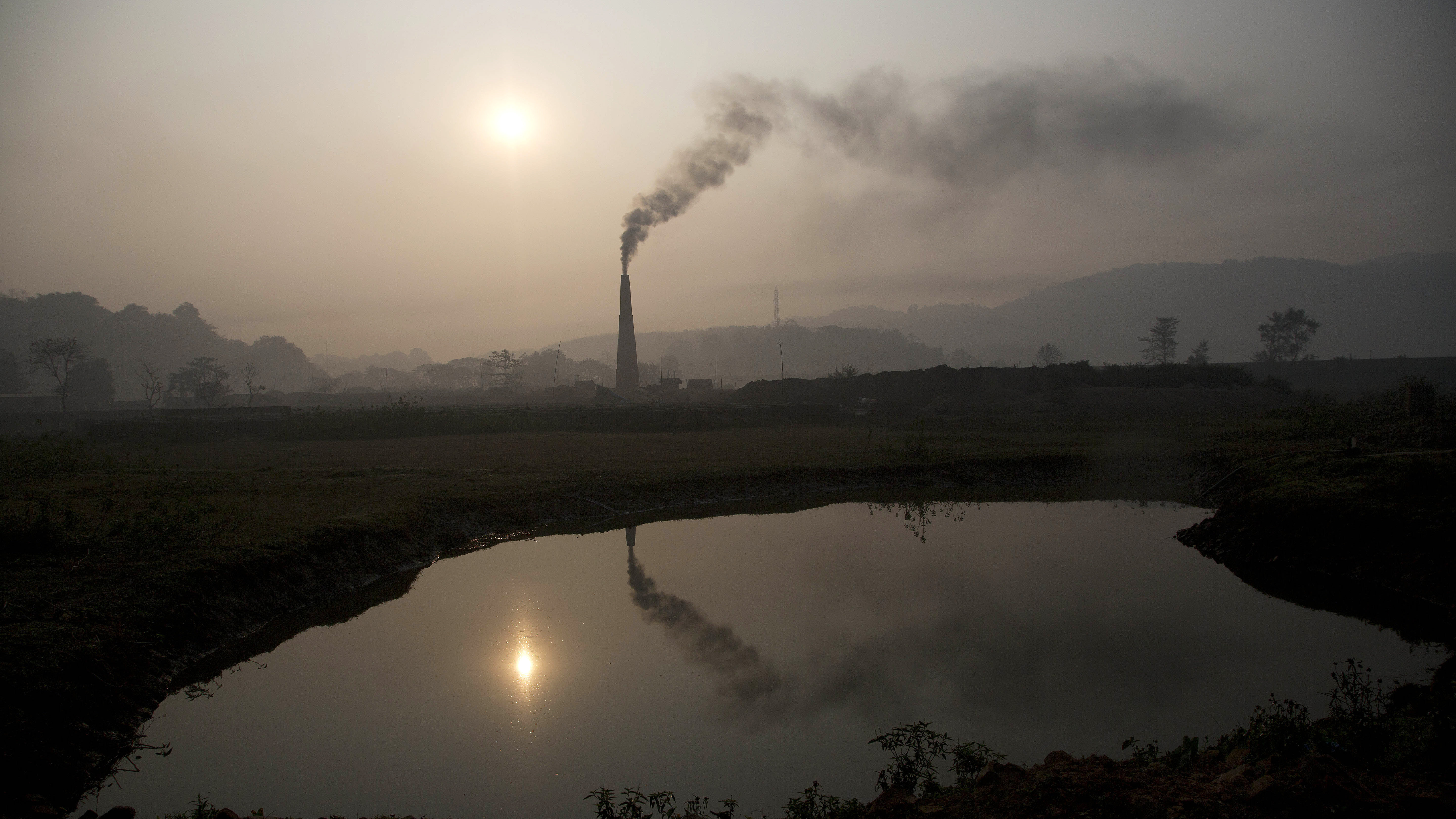 Smoke rises from a brick kiln on the outskirts of Gauhati, India, in 2015. India