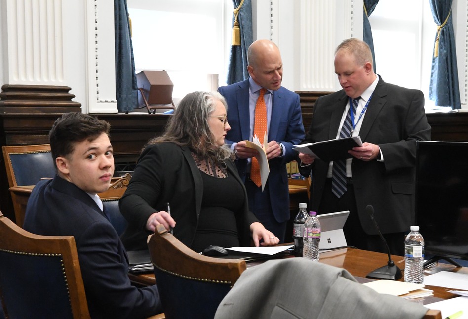 Kyle Rittenhouse looks on as defense attorneys Natalie Wisco and Corey Chirafisi look at exhibits before court with Assistant District Attorney James Kraus right during the trial of Kyle Rittenhouse on November 5, 2021 in Kenosha, Wisconsin. (Mark Hertzberg-Pool/Getty Images)