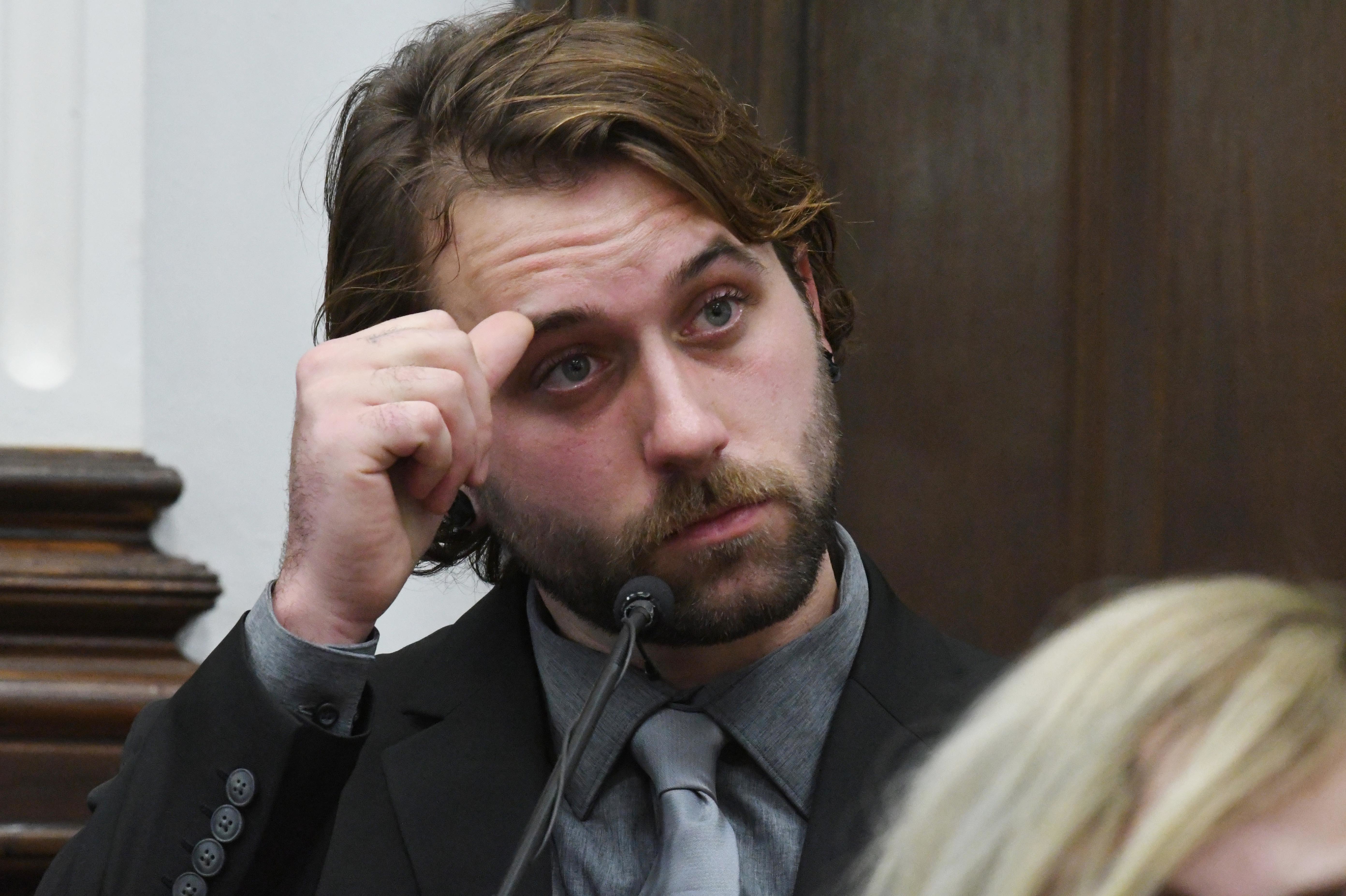 Gaige Grosskreutz watches video as he testifies about being shot in the right arm during the Kyle Rittenhouse trial at the Kenosha County Courthouse on Monday in Wisconsin. (Getty Images)