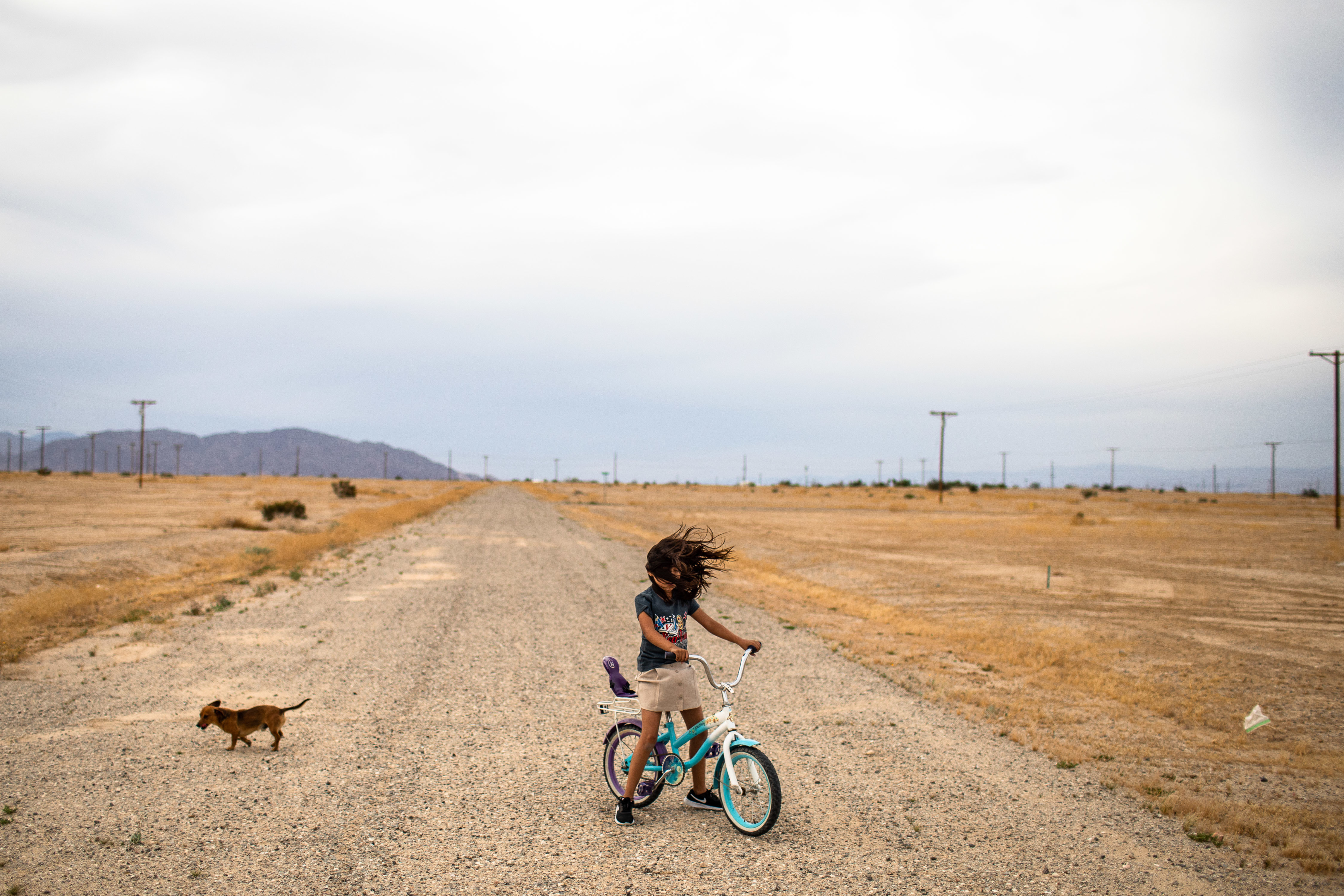 Songs and Pictures For Climate Change: A Playlist for the Planet 2 Salton City, near California's Salton Sea: Lizette plays on her bicycle as strong winds are blowing across her neighborhood. Little water enters the area and the water that does enter is all agricultural run off laced with pesticides and fertilizers. As the lake shrinks it exposes sand and dust that blows into the air exposing people living nearby to PM10 particulate dust.