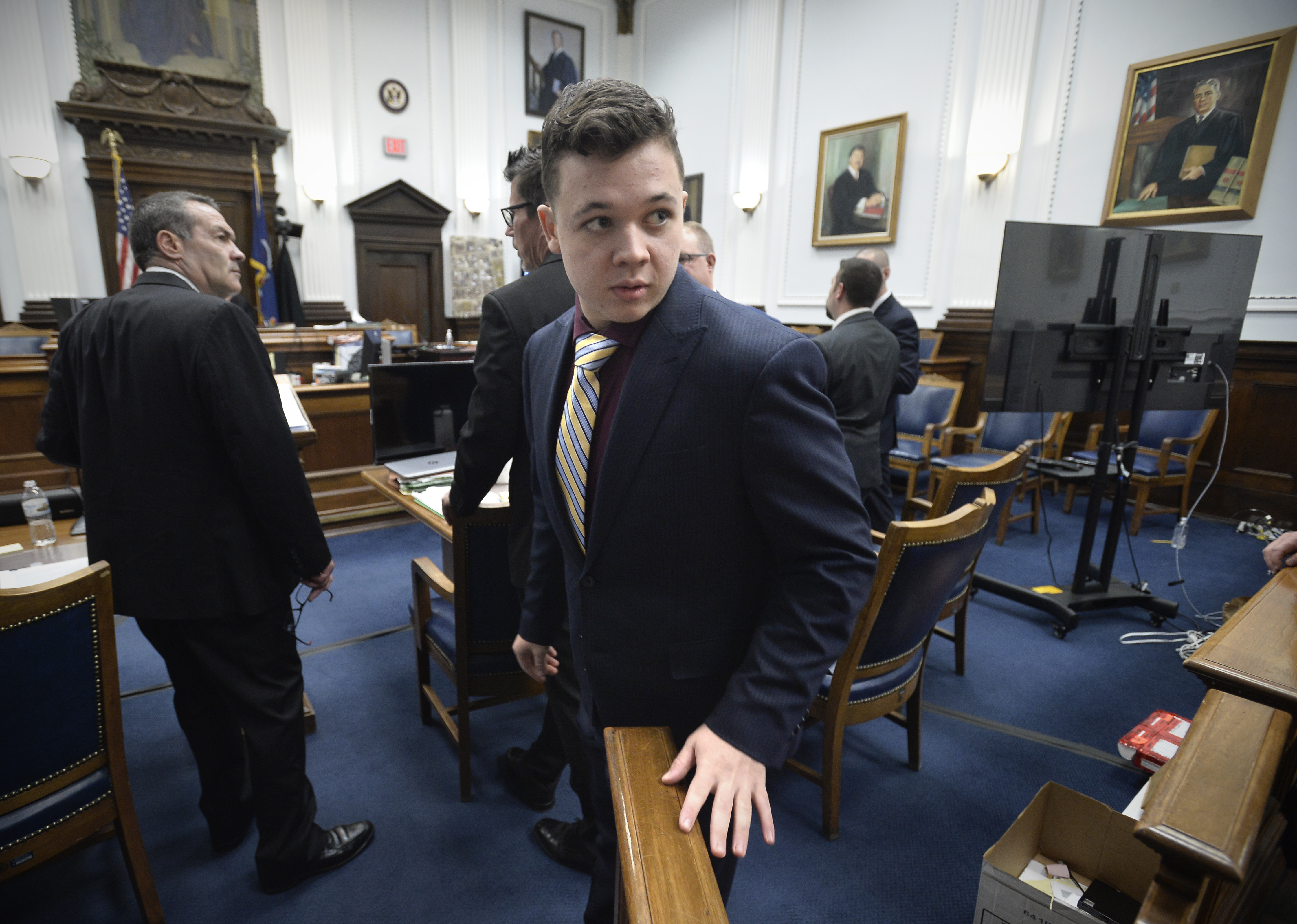 Kyle Rittenhouse (center) enters the courtroom after a break at the Kenosha County Courthouse on Thursday. Rittenhouse is charged in the killings of two people and wounding of a third during a racial justice protest in Kenosha, Wis., last year.