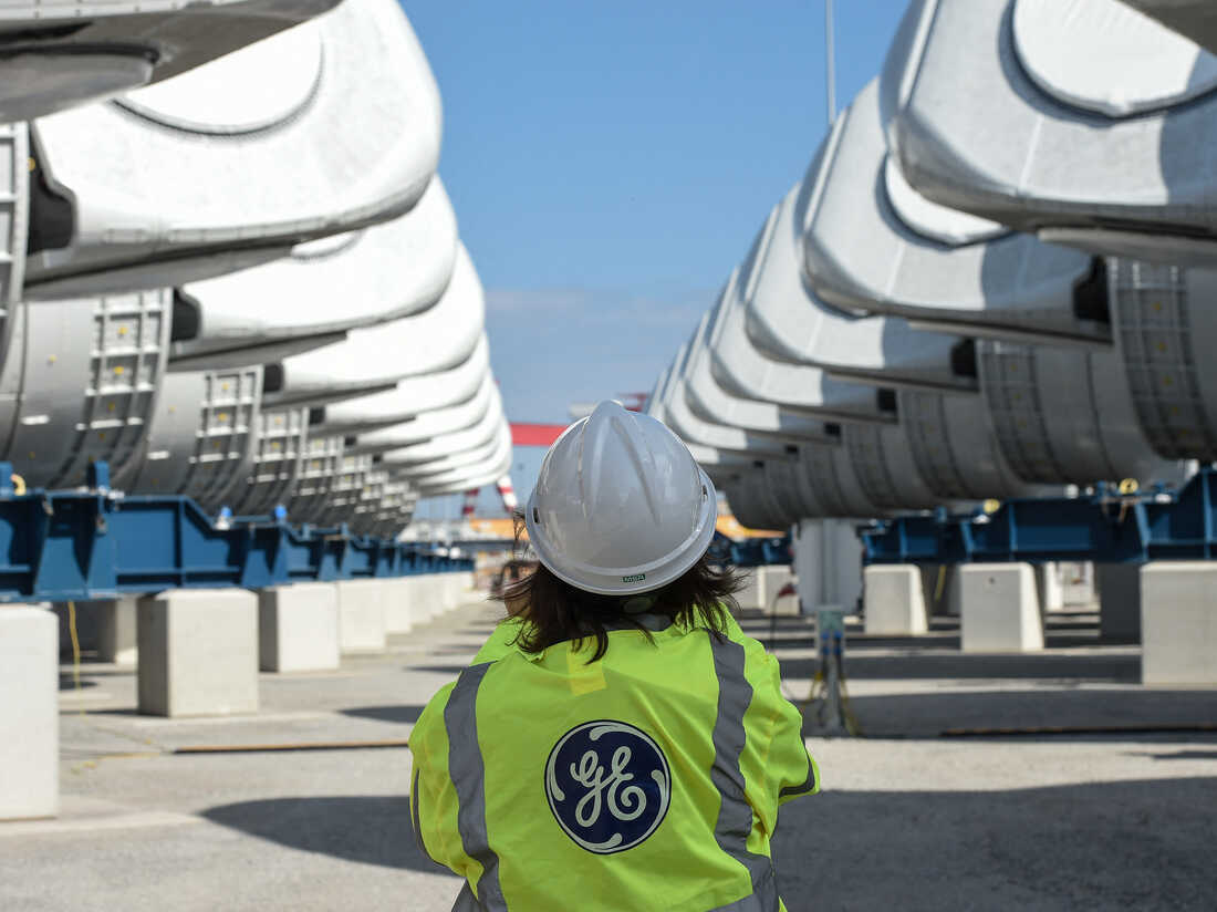 General Electric employee walks between wind turbine nacelles for the construction of a wind farm off Saint-Nazaire, in Saint-Nazaire, western France, on September 21, 2021. (Photo by Sebastien SALOM-GOMIS / AFP) (Photo by SEBASTIEN SALOM-GOMIS/AFP via Getty Images)
