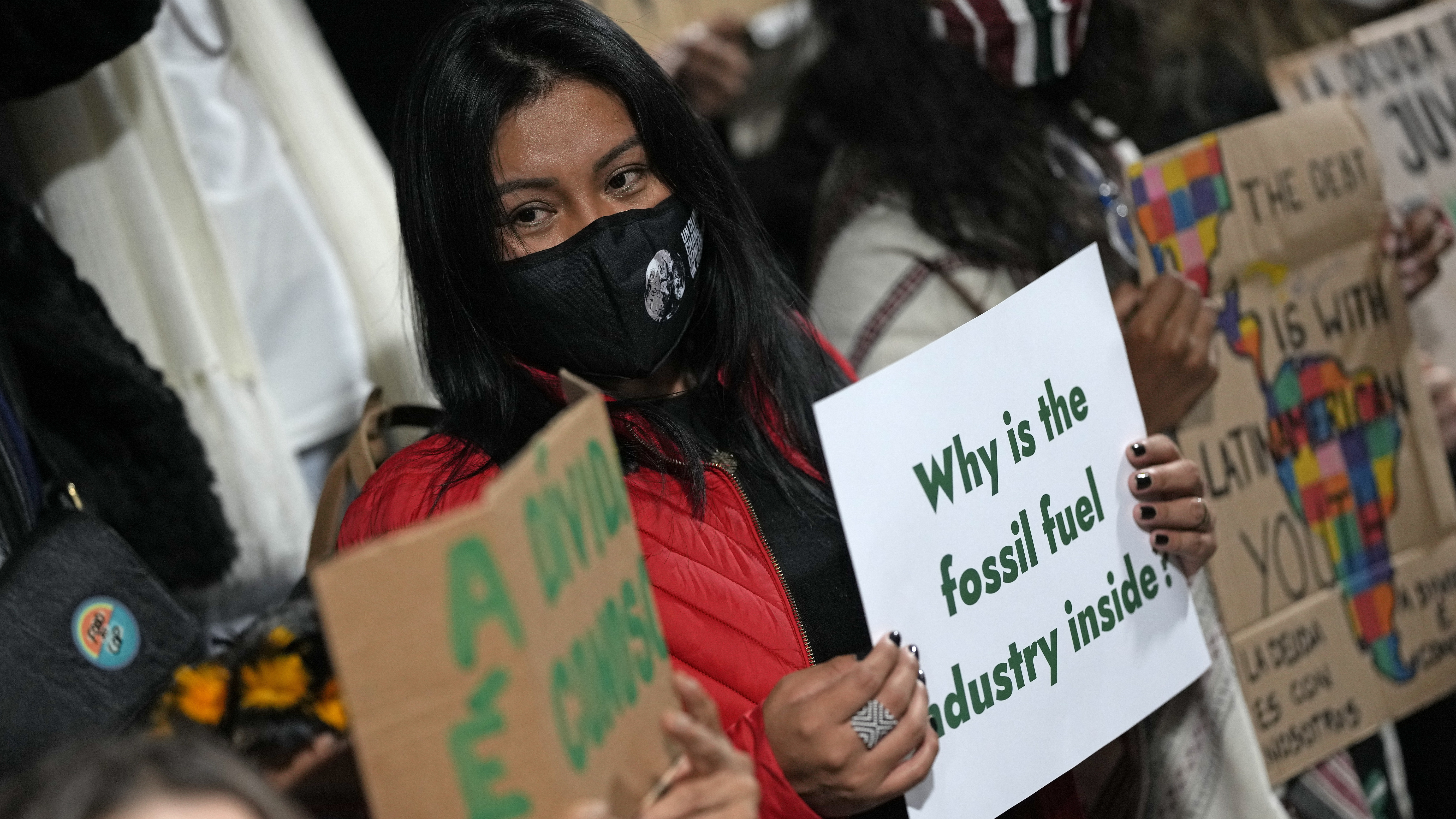 Youth climate activists protest on Thursday that representatives of the fossil fuel industry have been allowed inside the venue during the COP26 U.N. Climate Summit in Glasgow.