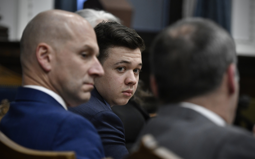 Kyle Rittenhouse (center) looks over to his attorneys as the jury is dismissed for the day on Thursday during his trial at the Kenosha County Courthouse in Kenosha, Wisconsin. (Pool/Getty Images)