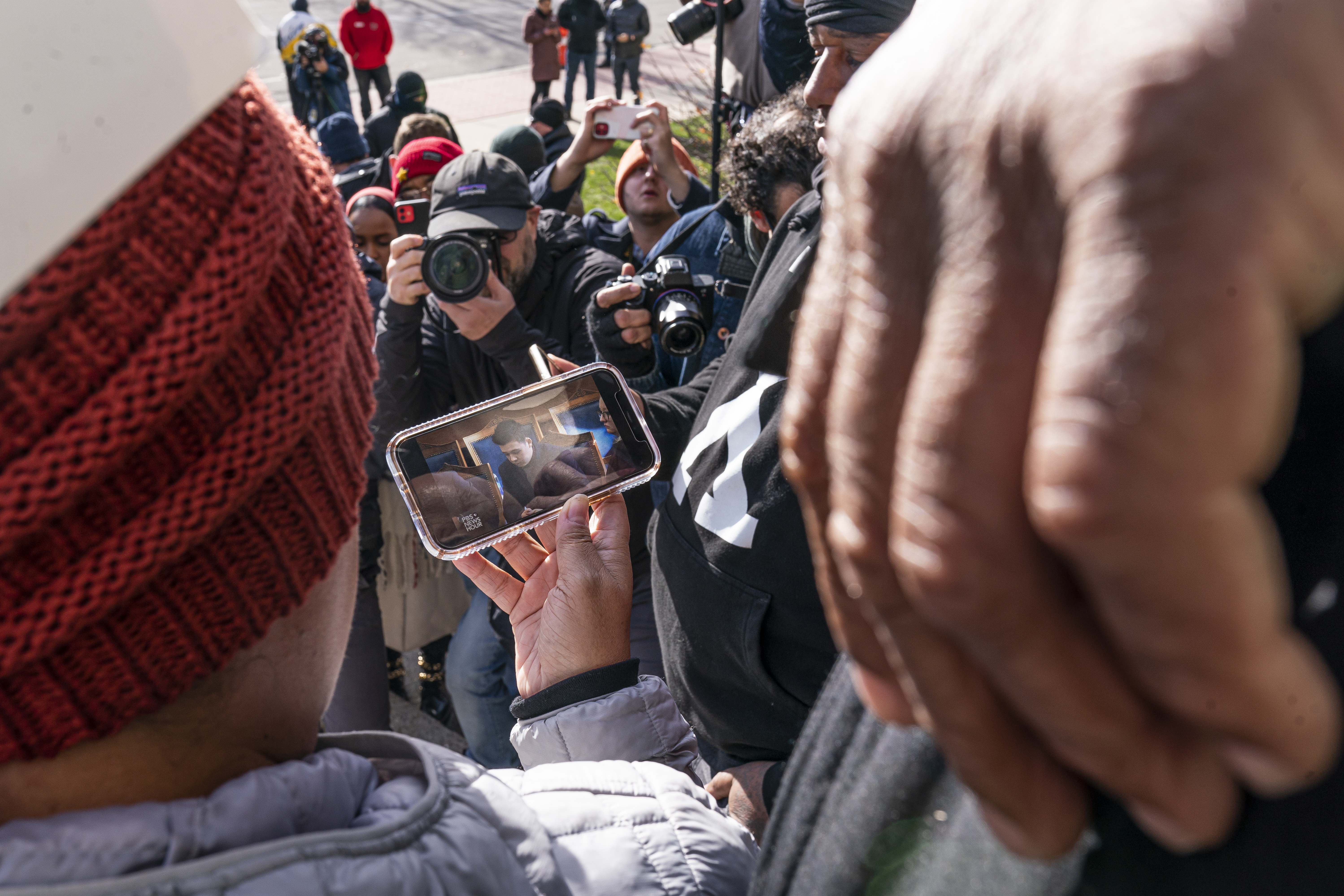 Bystanders on the steps of the courthouse watch as the verdict is read in the trial of Kyle Rittenhouse. Legal experts said Rittenhouse's claim of self-defense was strong from the beginning. (Getty Images)