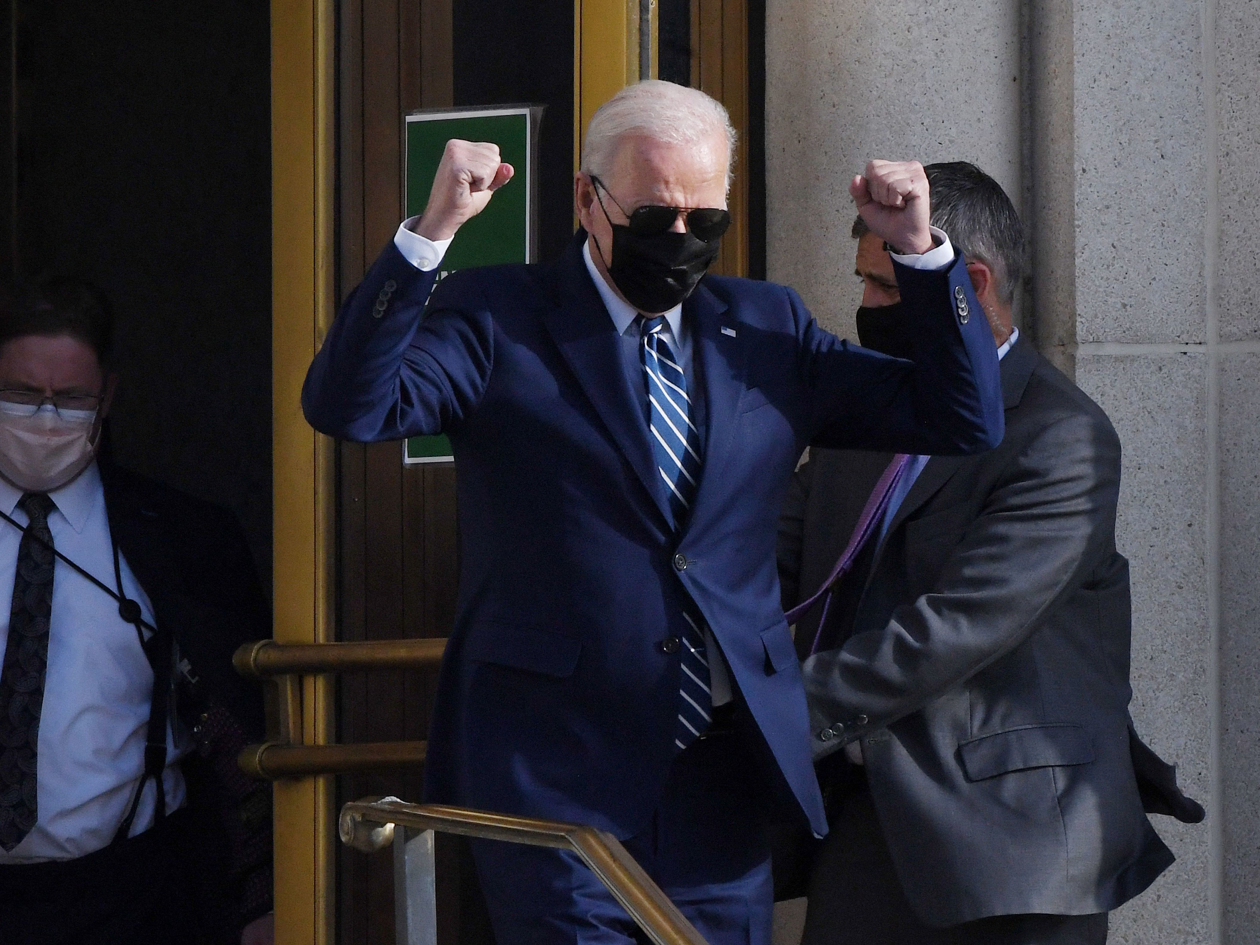 President Biden pumps his fists after getting a medical checkup as he departs Walter Reed Medical Center in Bethesda, Md., onÂ Friday. (AFP via Getty Images)