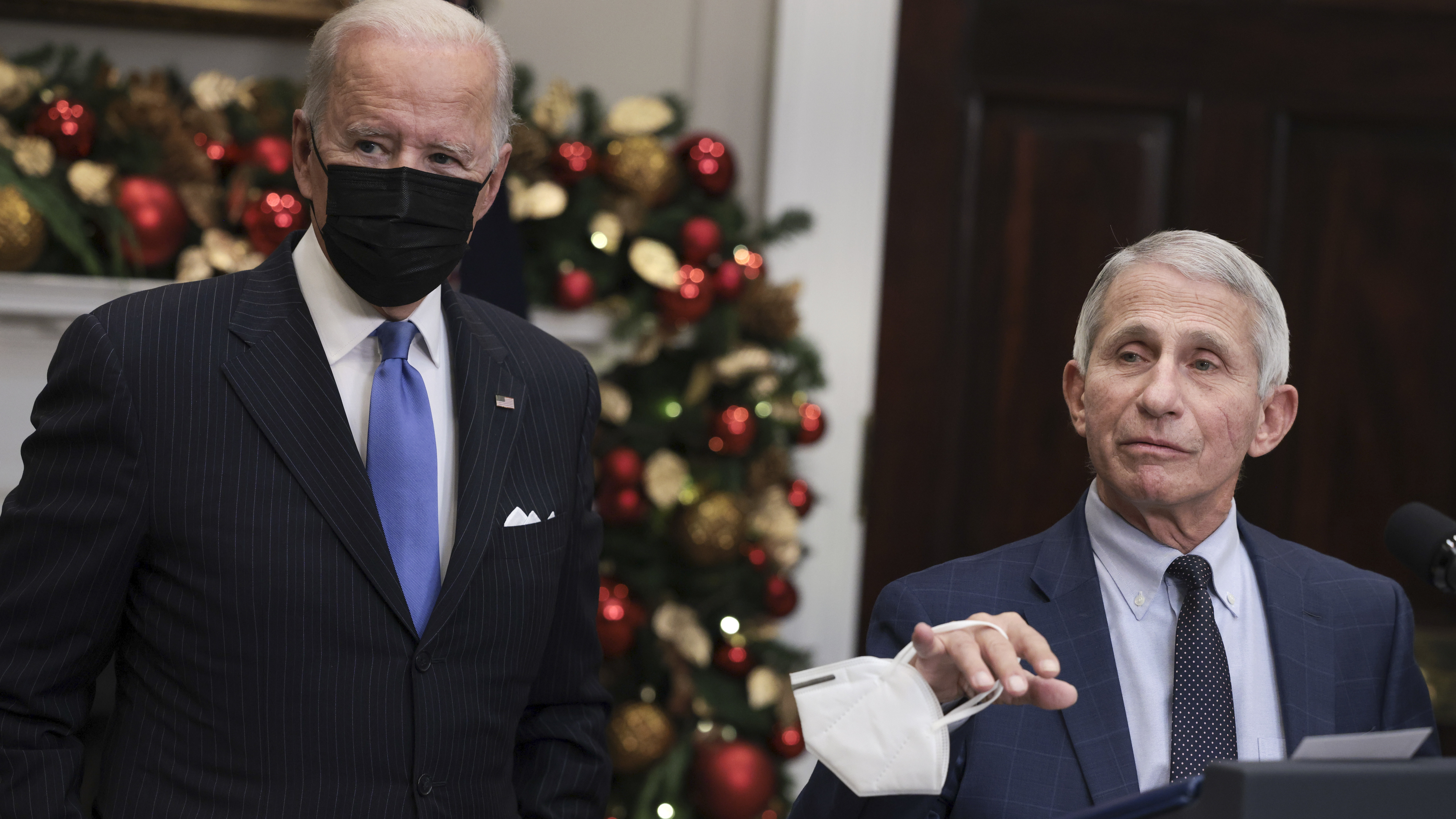 Anthony Fauci (right), director of the National Institute of Allergy and Infectious Diseases and chief medical adviser to the president, speaks alongside President Biden following a meeting of the COVID-19 response team at the White House on Monday. (Getty Images)