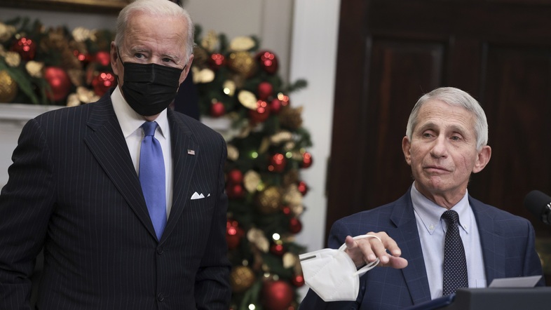 Anthony Fauci (right), director of the National Institute of Allergy and Infectious Diseases and chief medical adviser to the president, speaks alongside President Biden following a meeting of the COVID-19 response team at the White House on Monday. (Anna Moneymaker/Getty Images)