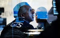 Traders work on the floor of the New York Stock Exchange at the start of trading on Monday following Friday's steep decline in global stocks over fears of the new omicron coronavirus variant discovered in South Africa.