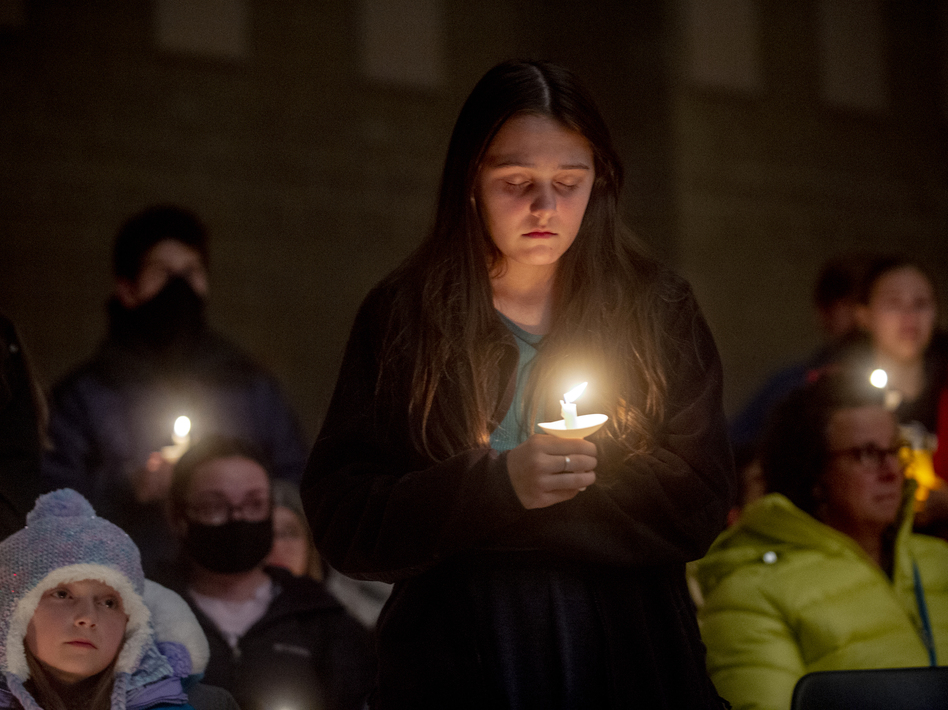 Students hold candles during a prayer vigil after the shootings at Oxford High School on Tuesday in Oxford, Mich. (Jake May/The Flint Journal via AP)