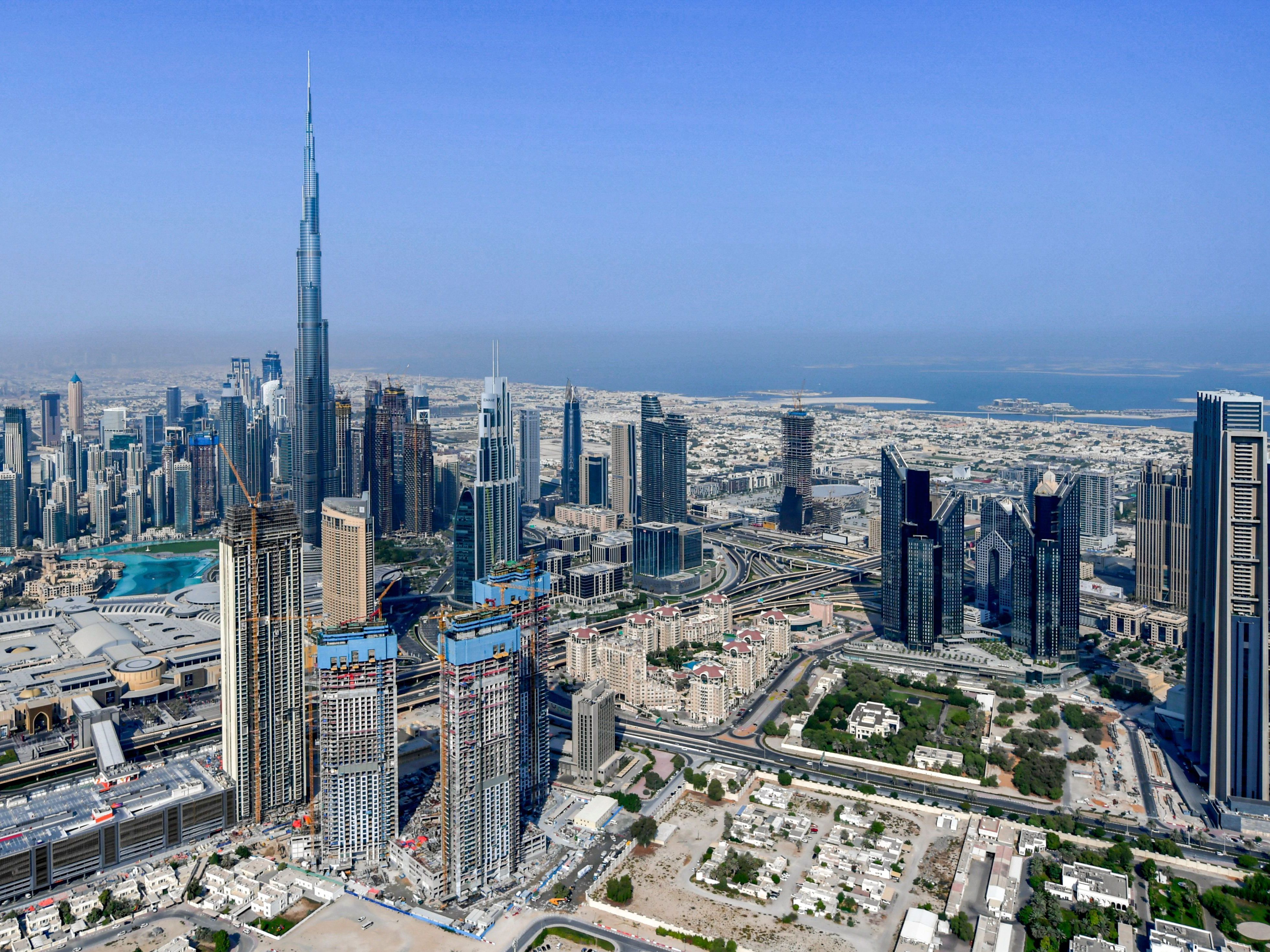 The United Arab Emirates is changing its workweek to have half days on Fridays and a Saturday-Sunday weekend. Here, the country's emirate of Dubai and its Burj Khalifa skyscraper are photographed from a helicopter on July 8, 2020. (AFP via Getty Images)