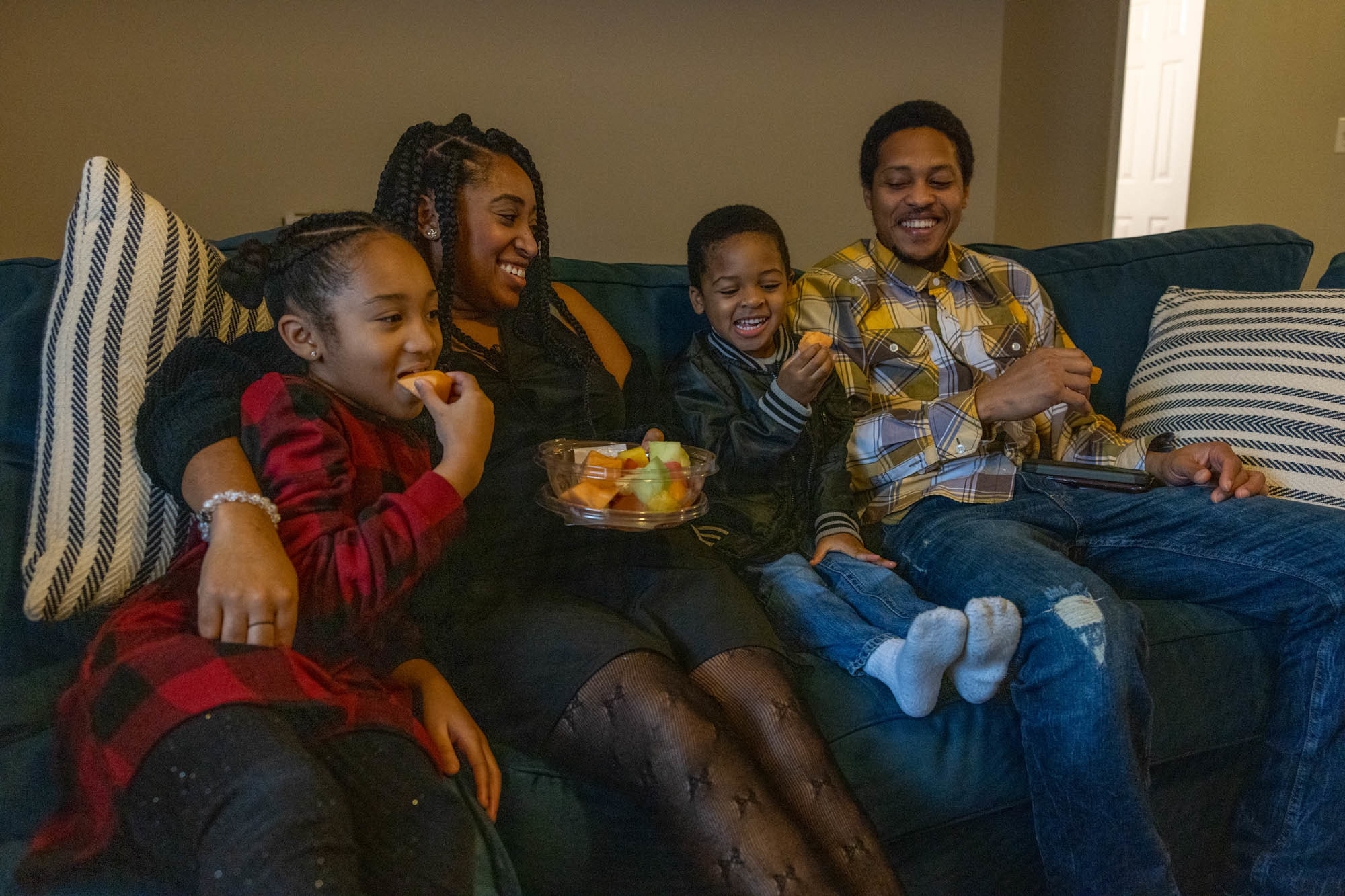 Nicole Howson spends time in her new living room with her family. (NPR)