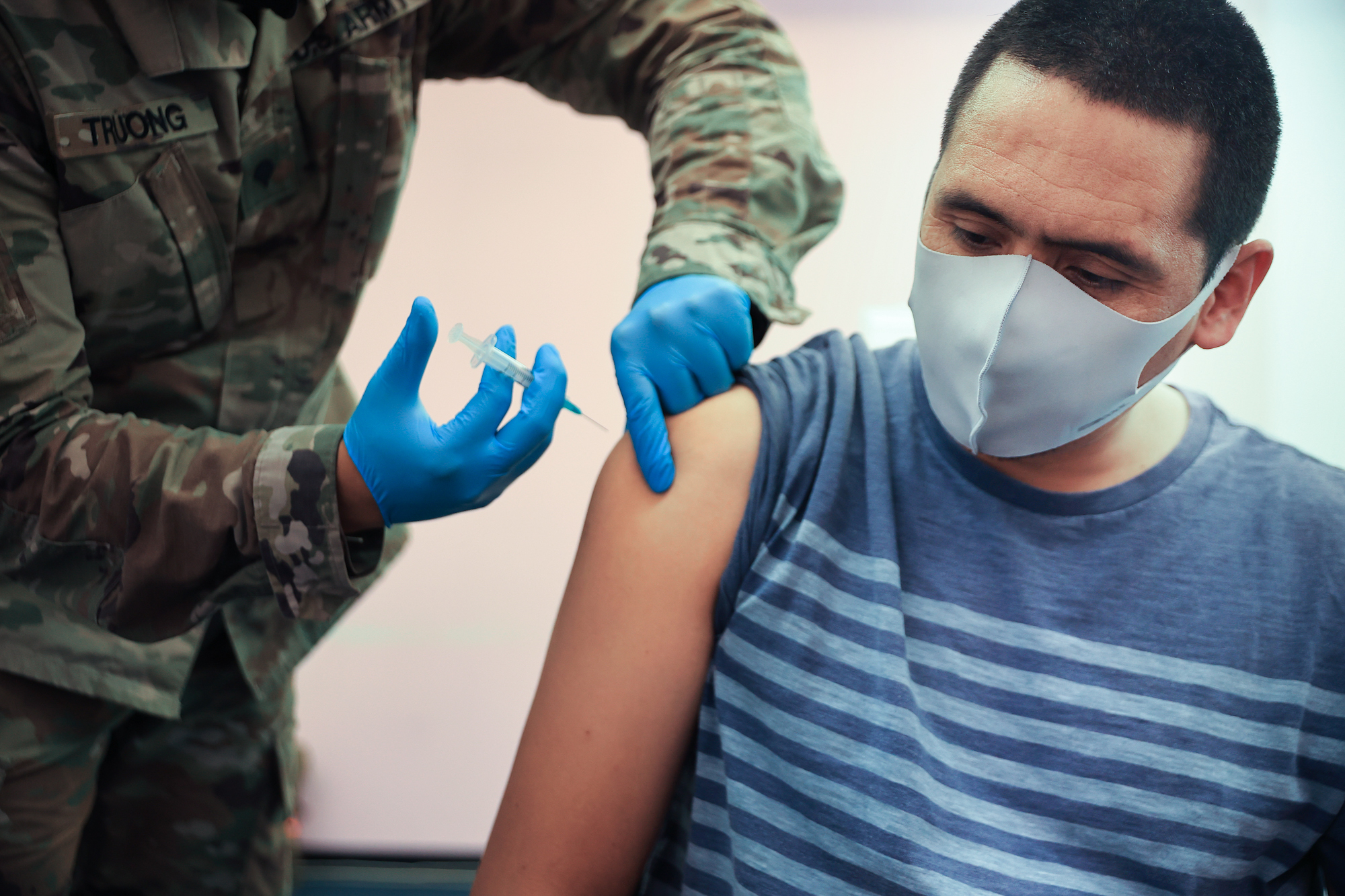 Maryland National Guard Spc. James Truong administers a Moderna COVID-19 vaccine on May 21 in Wheaton, Maryland. People vaccinated with the Moderna vaccine likely need a booster to keep up their protection against the new omicron variant of the coronavirus. (Chip Somodevilla/Getty Images)