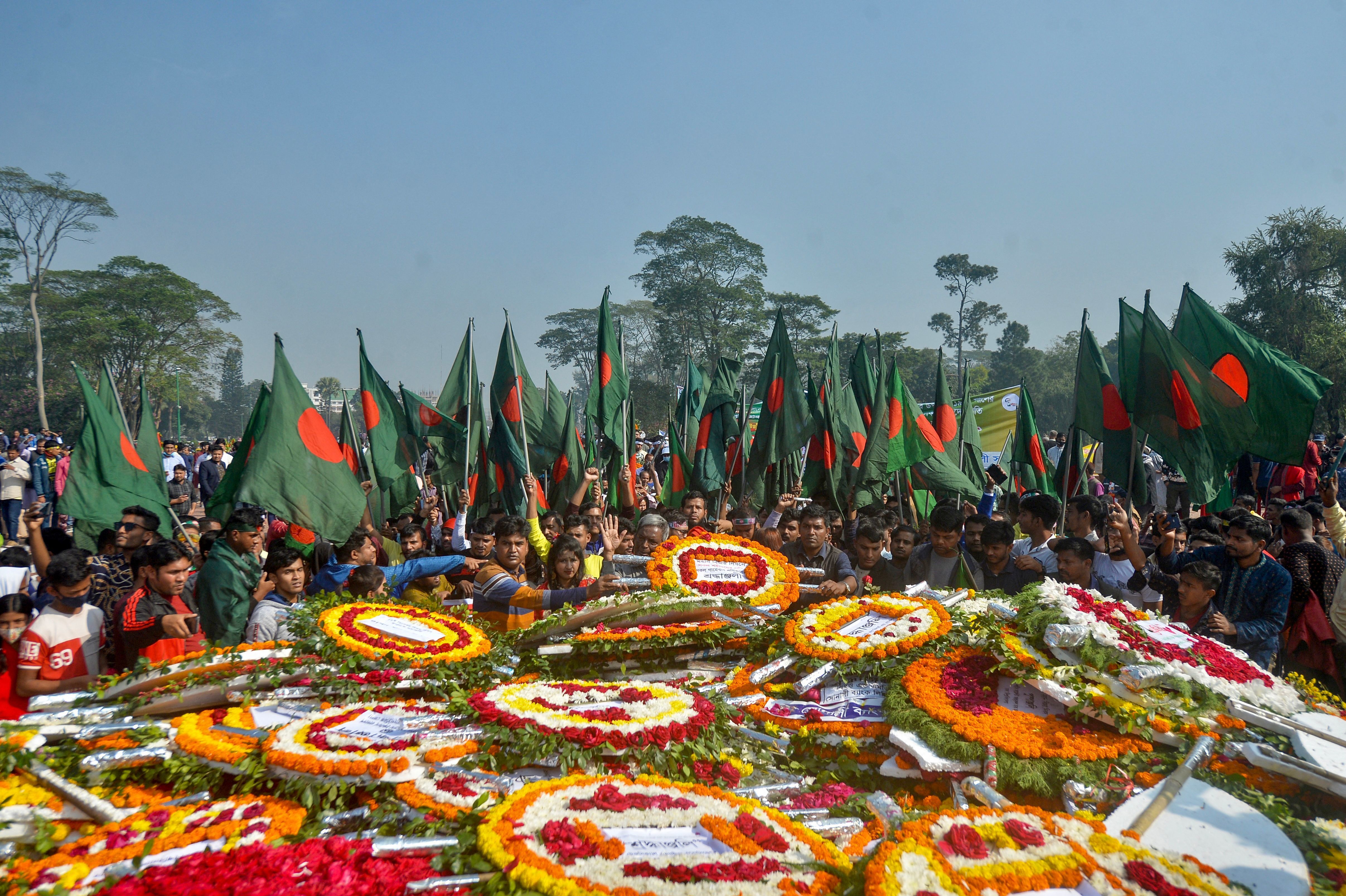 People gather to pay their respects at the 1971 independence war martyrs national memorial to celebrate the 50th Victory Day, which marks the end of a nine-month war of independence from Pakistan, in Savar, Bangladesh, on Thursday. (AFP via Getty Images)
