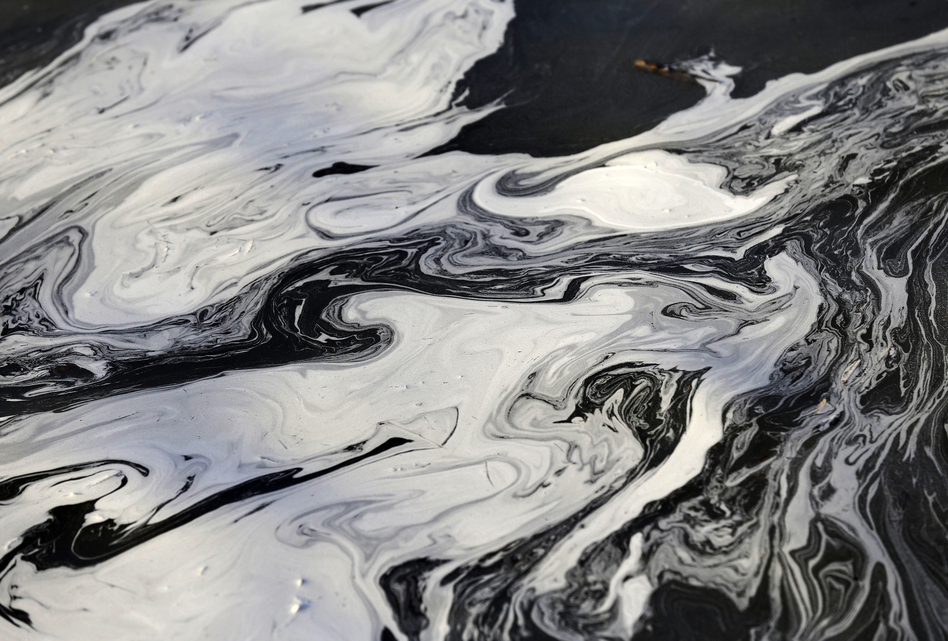 Coal ash swirls on the surface of the Dan River on Feb. 5, 2014 after tens of thousands of tons of coal ash spilled from a Duke Energy power plant into the Dan River at Eden, North Carolina, causing damage for 70 miles downstream.