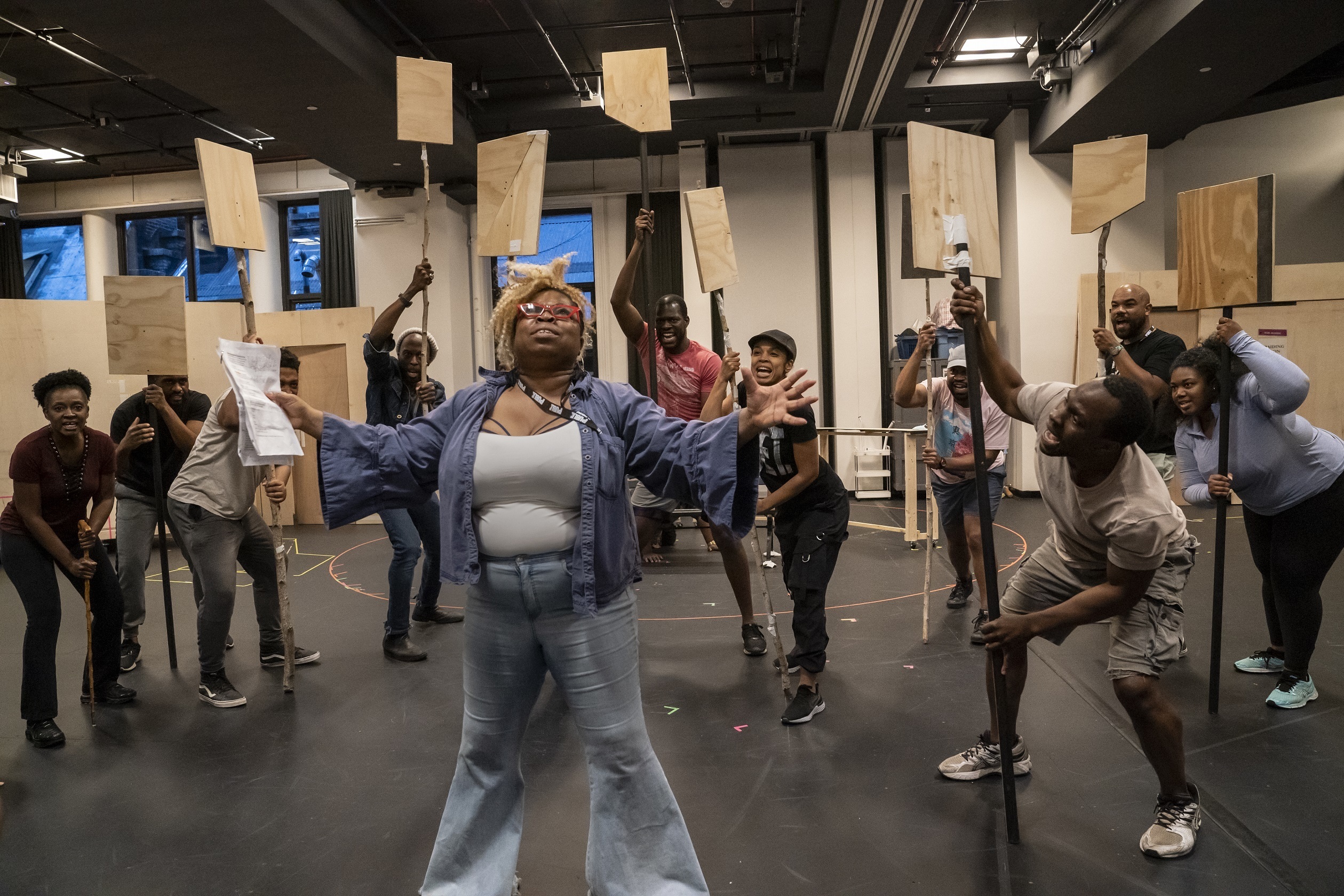 Shola Adewusi (foreground) and the company in rehearsal for <em>Merry Wives. </em>When the show first began its run, the audiences were mostly white. Then, the organization piloted Black theater nights, says the Public Theater's artistic director, Oskar Eustis. &quot;And we had two nights in which the Delacorte was 98 percent Black audiences, 1500 people a night.&quot; (Courtesy of the Public Theater)