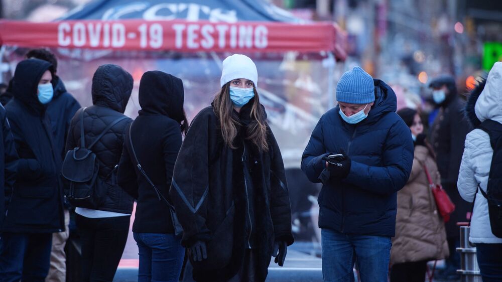 People wait at a street-side testing booth in New York's Times Square on Monday. (AFP via Getty Images)