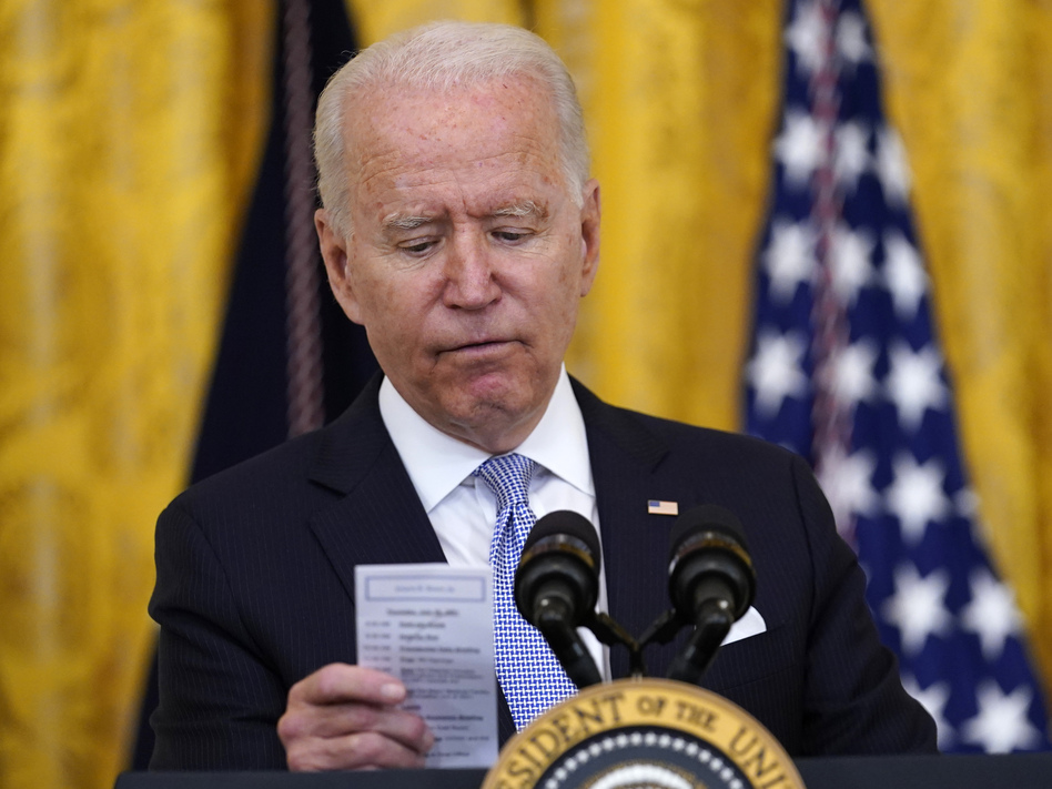 President Biden reads the number of COVID-19 deaths from a card he keeps in his pocket on July 29, 2021. (Susan Walsh/AP)