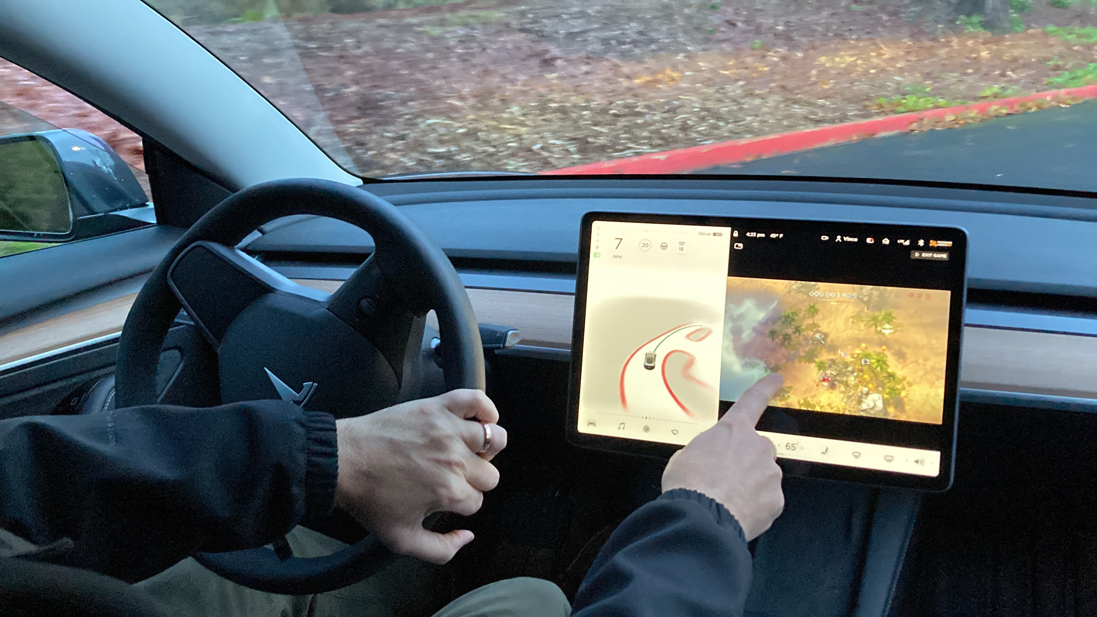 A new Tesla owner demonstrates earlier this month on a closed course in Portland, Ore., how he can play video games on the vehicle