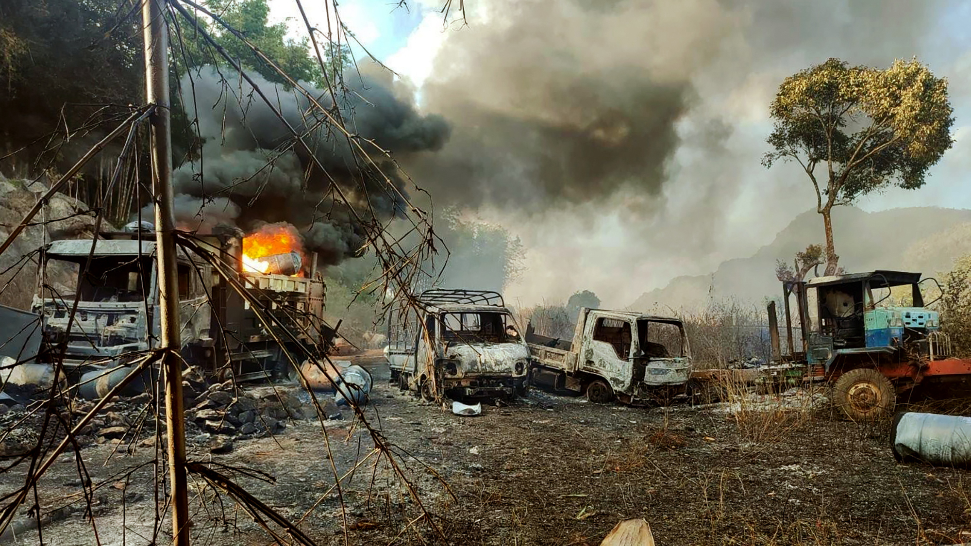 Smoke and flames billow from vehicles in Myanmar
