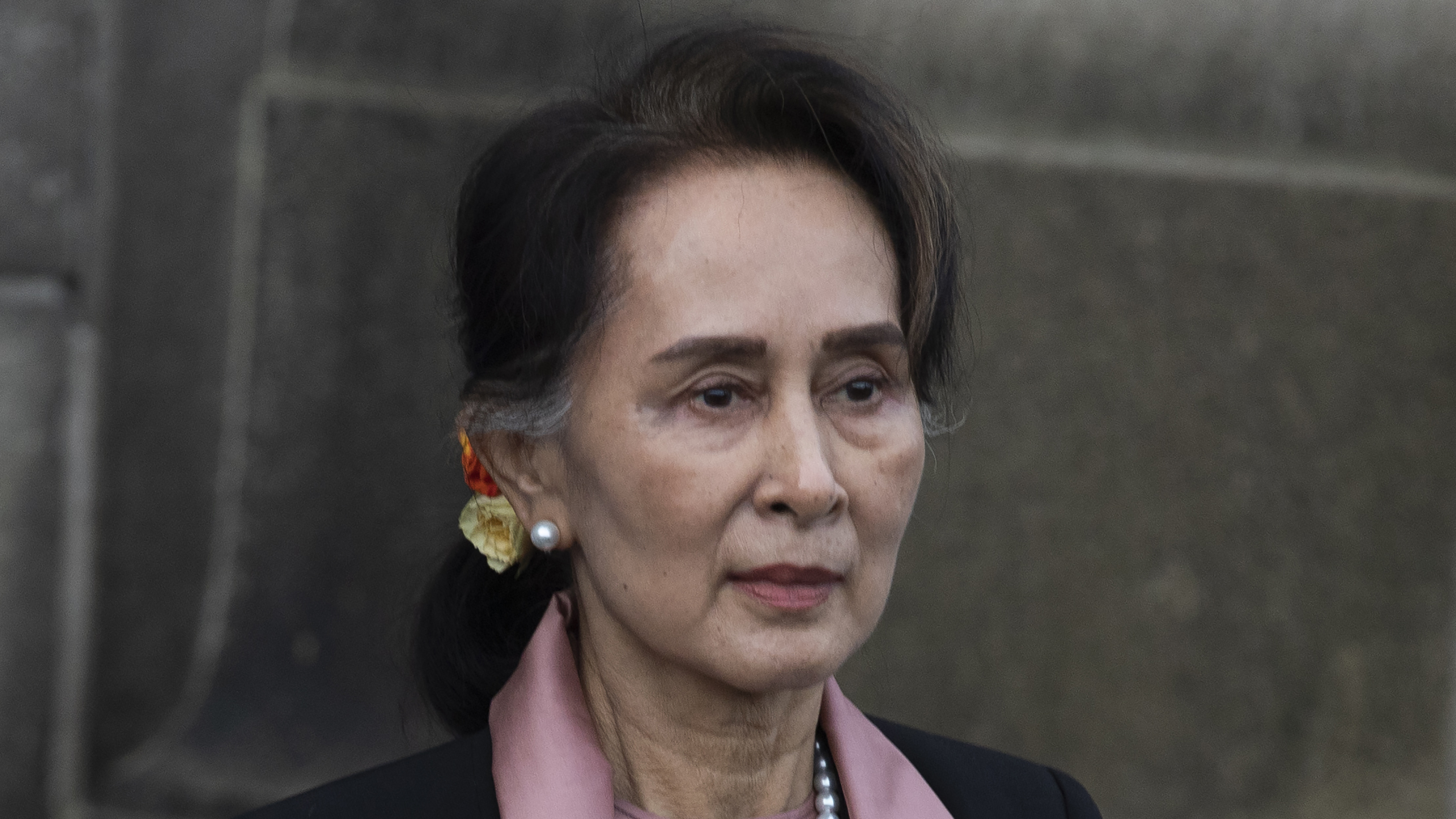 Aung San Suu Kyi leaves the International Court of Justice after the first day of three days of hearings in The Hague, Netherlands, in this December 2019 photo. She is charged with importing and possessing walkie-talkies without following official procedures, a legal official familiar with the case said.