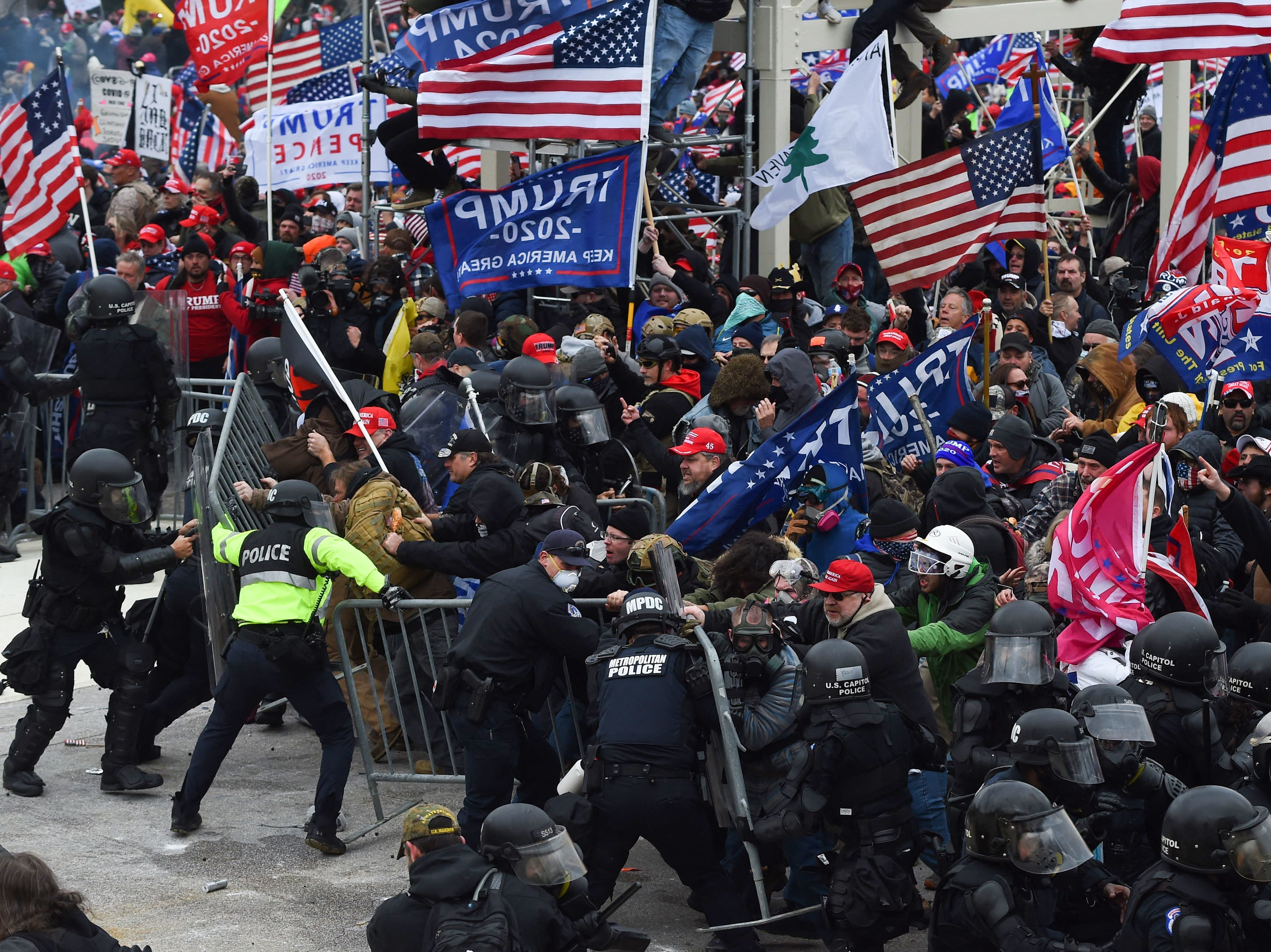 Trump supporters clash with police and security forces as they push barricades to storm the Capitol on Jan. 6, 2021.