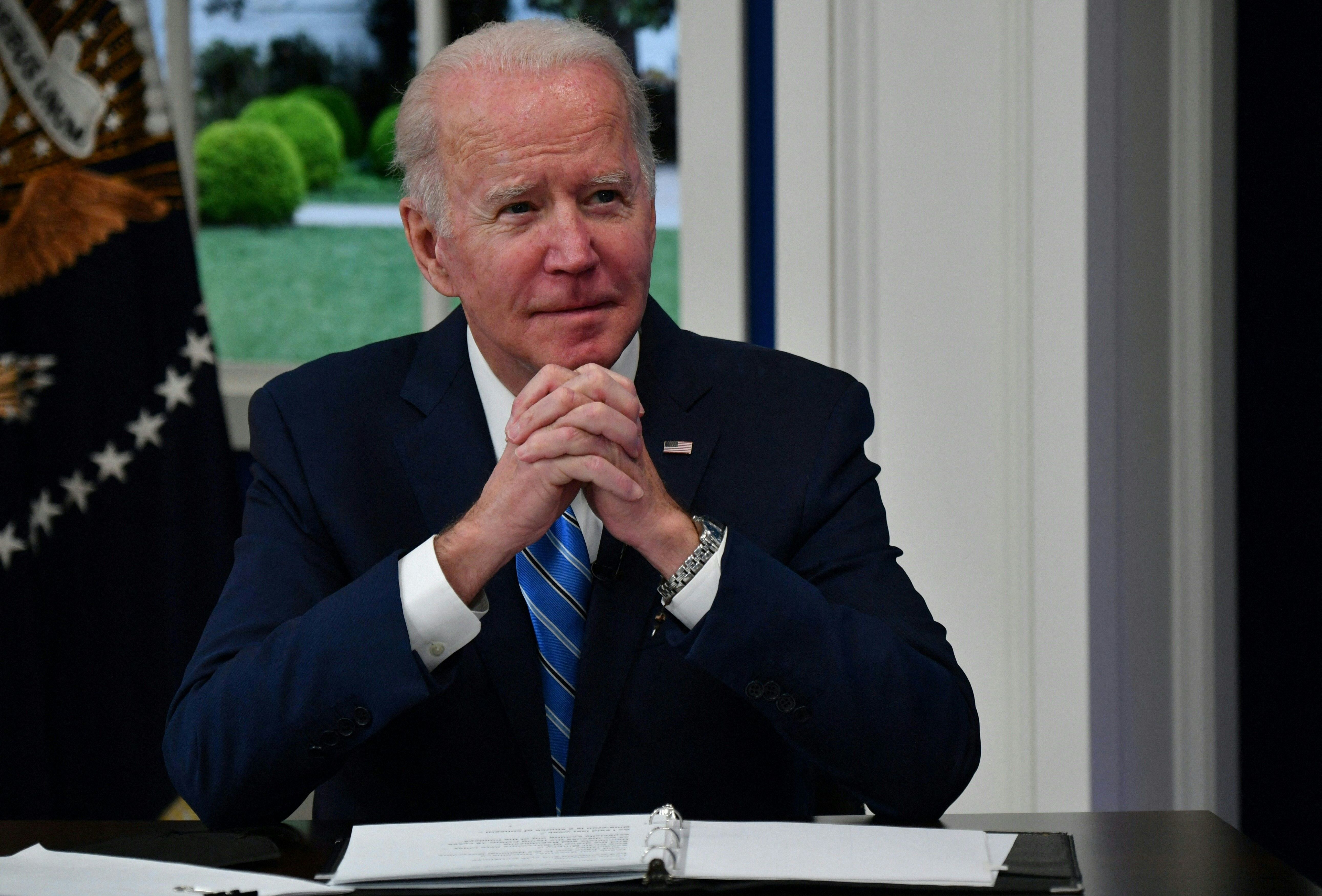 Toward the end of 2021, President Biden's approval ratings took a dive. Two things in particular need to improve for Biden to make a turnaround — the pandemic needs to lessen and price increases need to let up. (AFP via Getty Images)