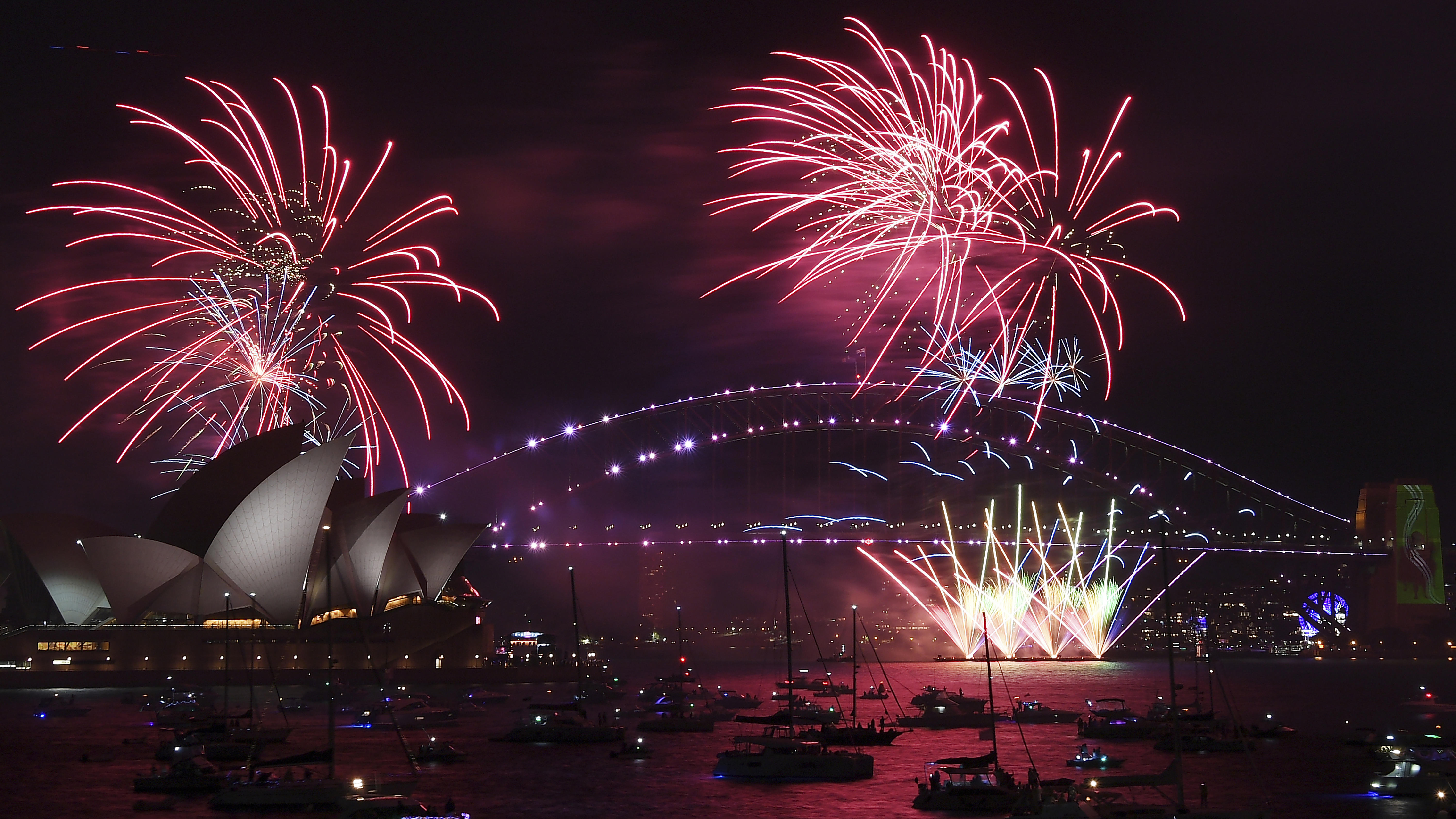 Fireworks explode over the Sydney Opera House and Harbour Bridge as New Year