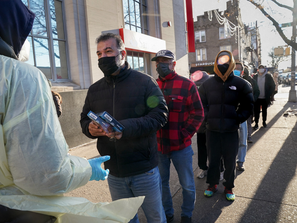 COVID-19 rapid tests are distributed in Brooklyn in late December. Self-tests are in short supply in many parts of the country. (Bryan R. Smith/AFP via Getty Images)