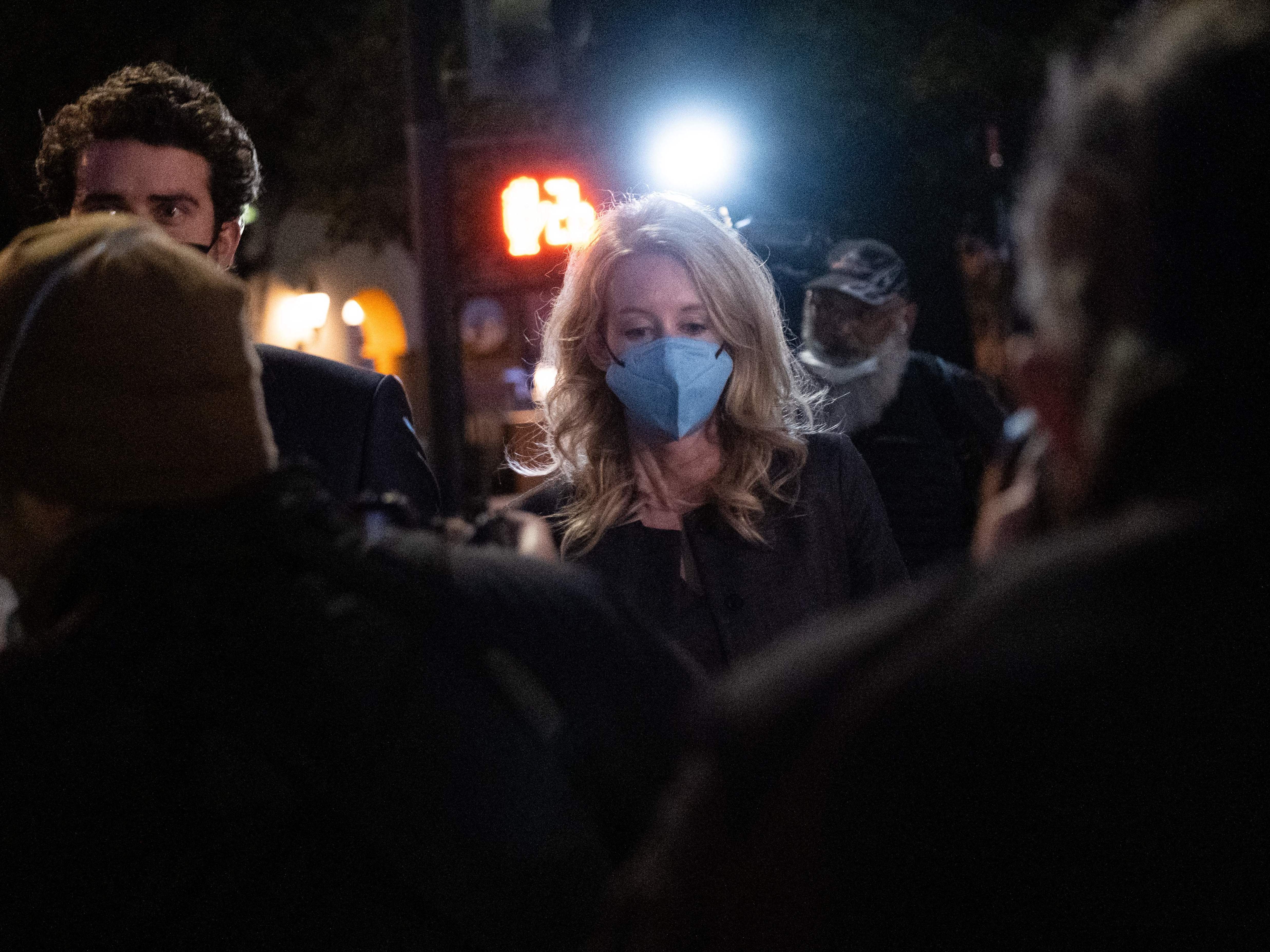 Elizabeth Holmes and partner Billy Evans walk outside the federal court in San Jose, California on January 3. (AFP via Getty Images)