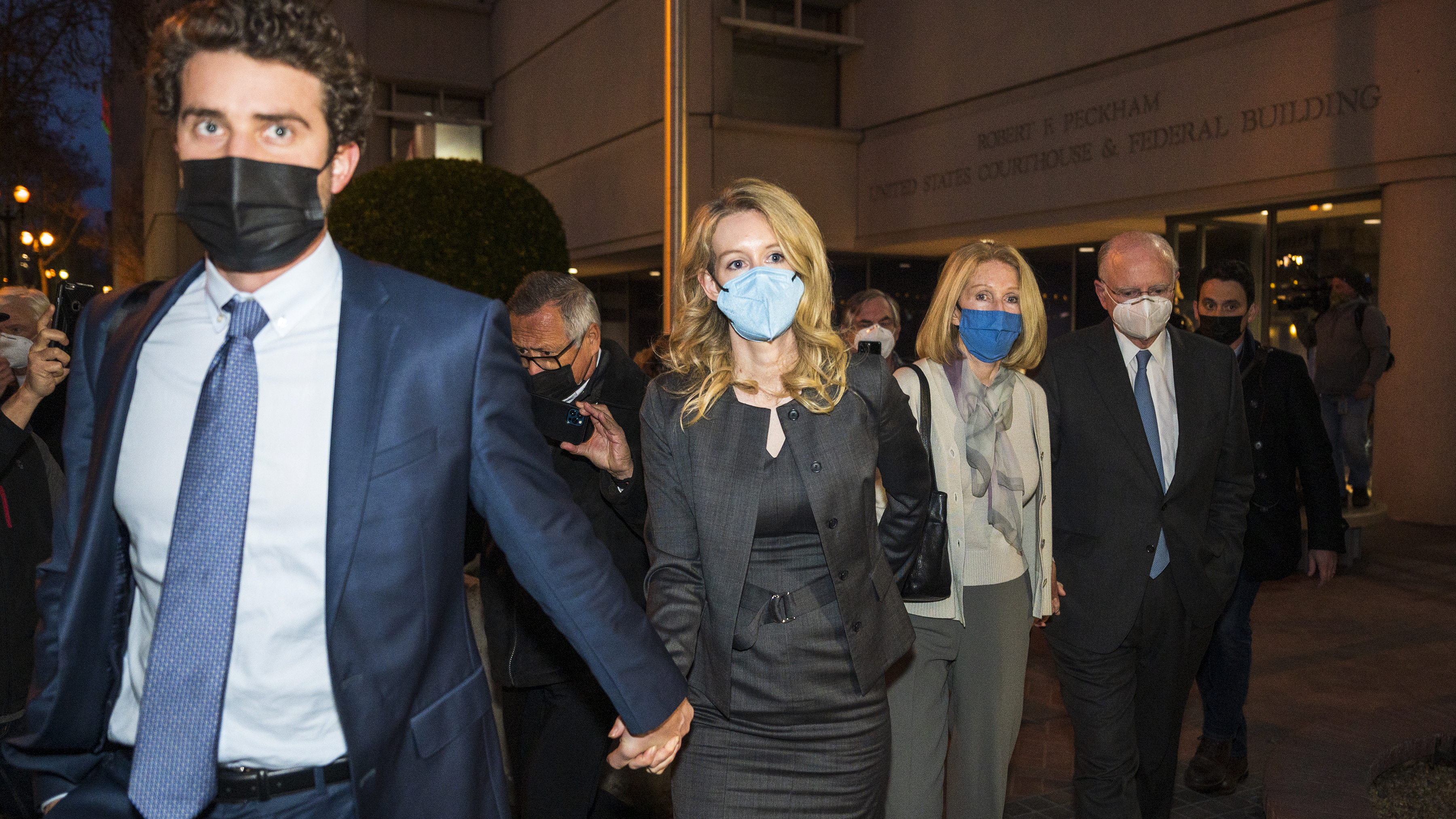 Elizabeth Holmes, center, leaves federal court on Jan. 3 after her verdict in San Jose, Calif. A judge on Wednesday set her sentencing date for Sept. 26 following her conviction on fraud charges.