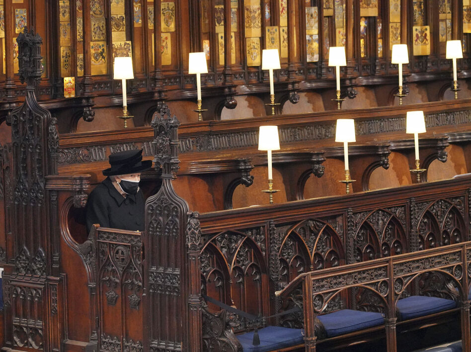 Queen Elizabeth II sits alone in St. George's Chapel on April 17, 2021, during the funeral of Prince Philip.