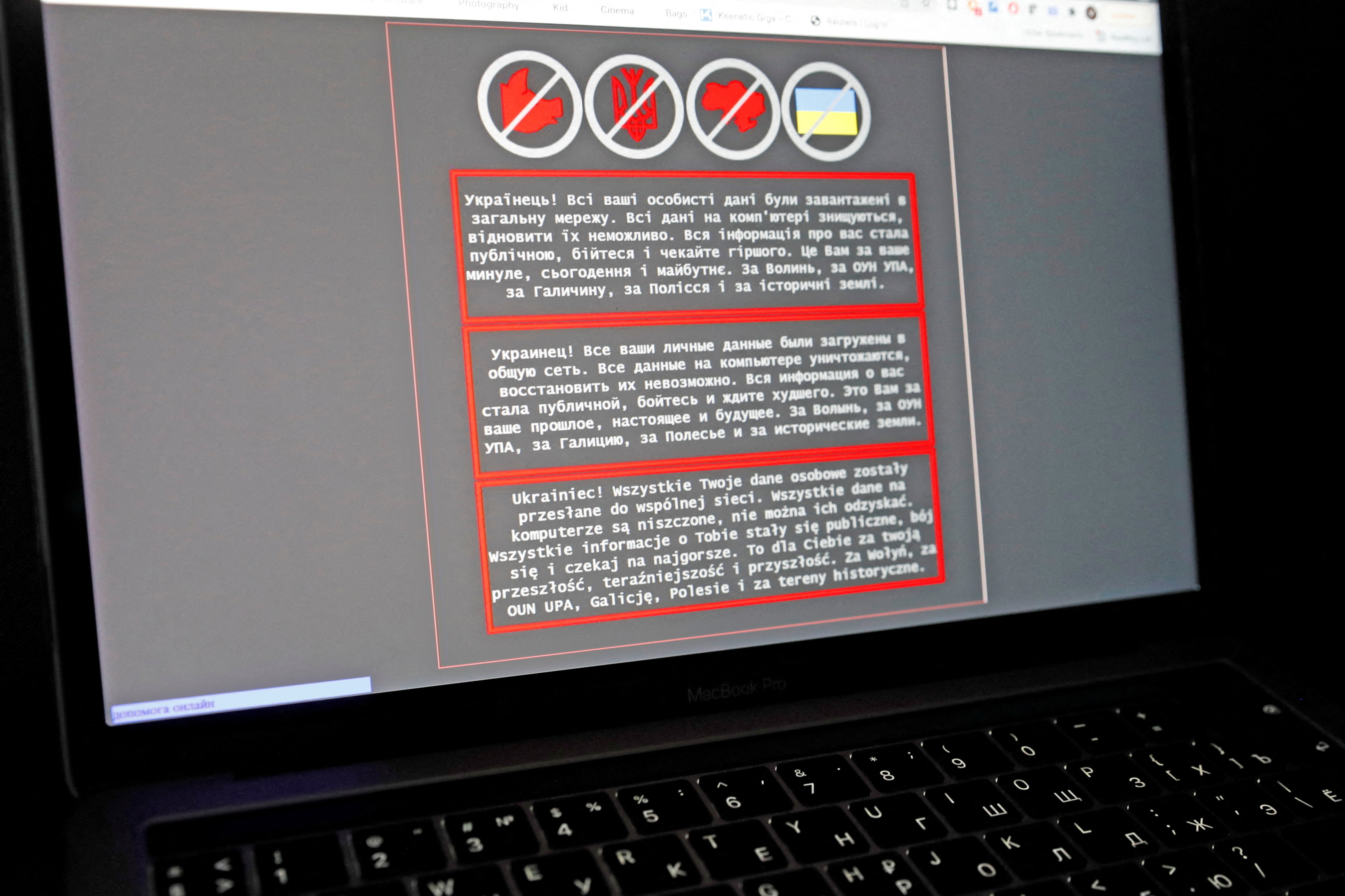 A laptop screen displays a warning message in Ukrainian, Russian and Polish that appeared on the official website of the Ministry of Foreign Affairs of Ukraine after a massive cyberattack on Friday. (Reuters)