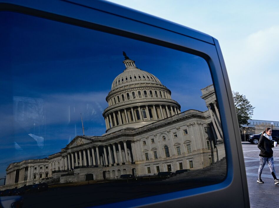 A reflection of the U.S. Capitol on a car window on Jan. 13, the day President Biden met with Senate Democrats to talk about voting rights legislation. (Mandel Ngan/AFP via Getty Images)