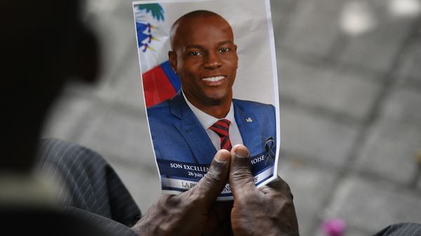 A person holds a photo of late Haitian President Jovenel Moïse during his memorial ceremony in Port-au-Prince, Haiti, on July 20, 2021.